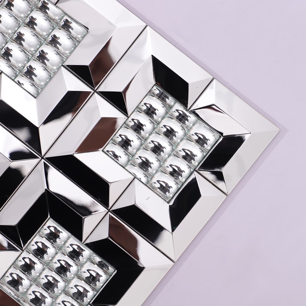 Corner close-up of silver mirror metal mosaic with raised glass center