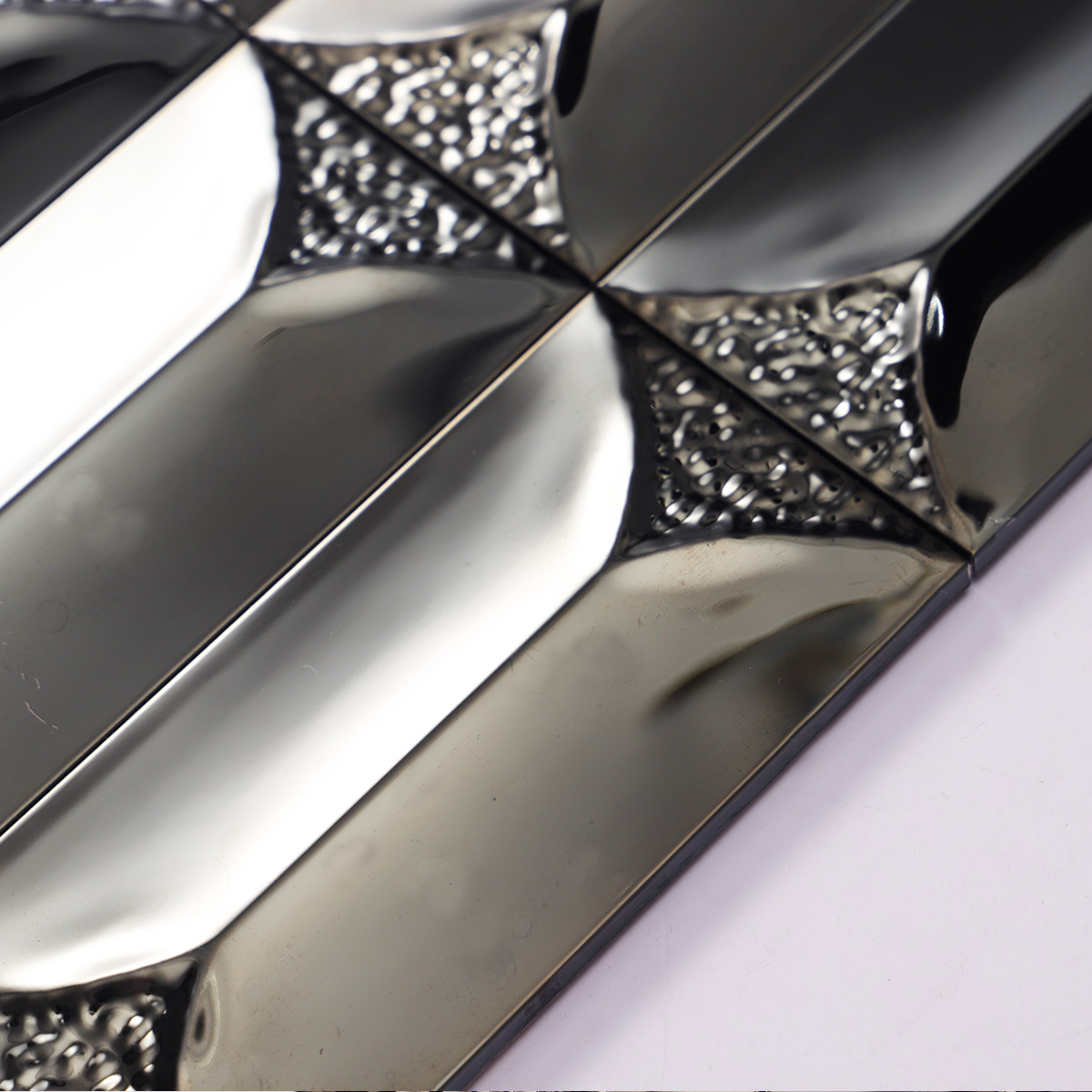 Texture close-up of 3D black mirror metal rectangle mosaic tiles.
