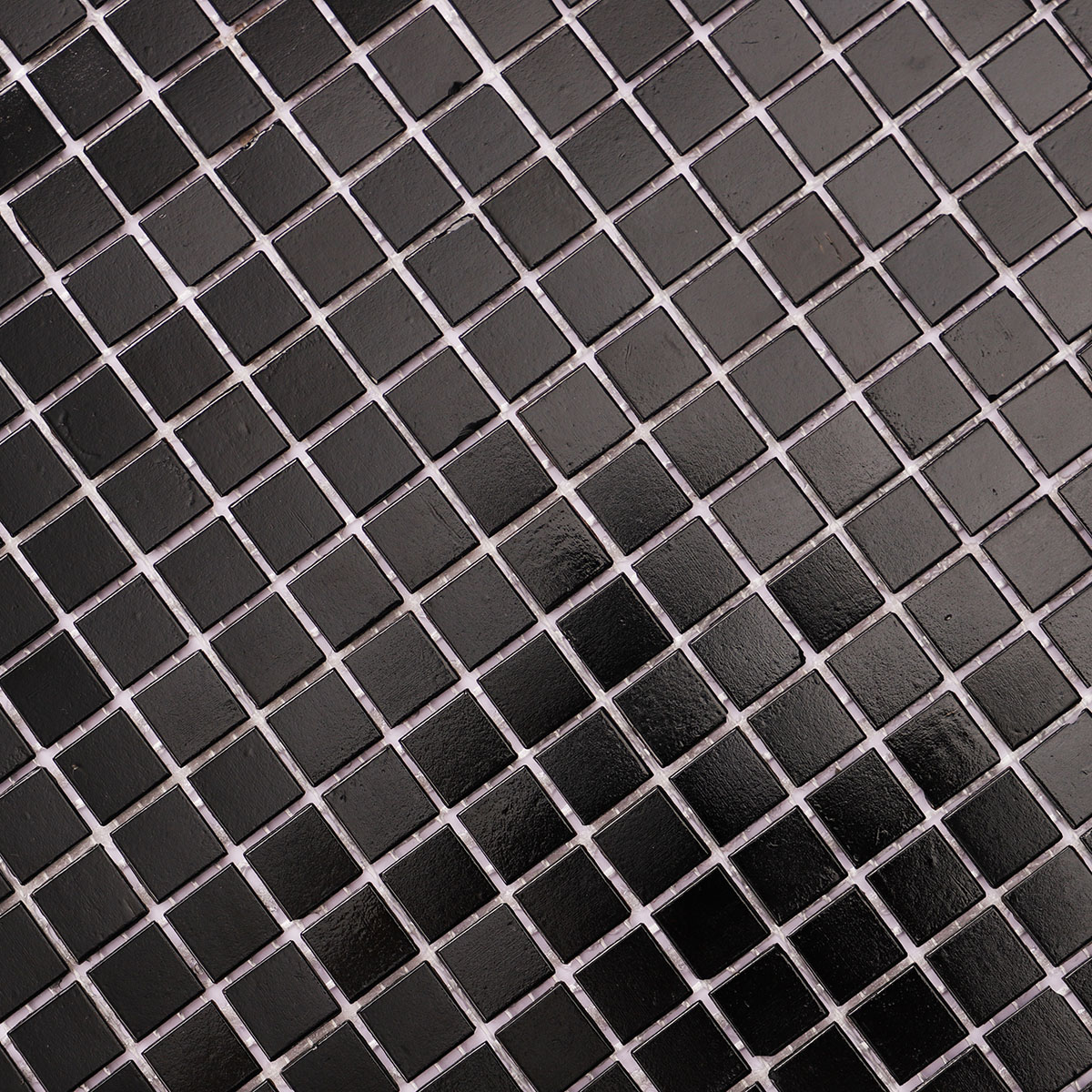 Close-up of black square fired earth glass mosaic tiles 15mm x 15mm.