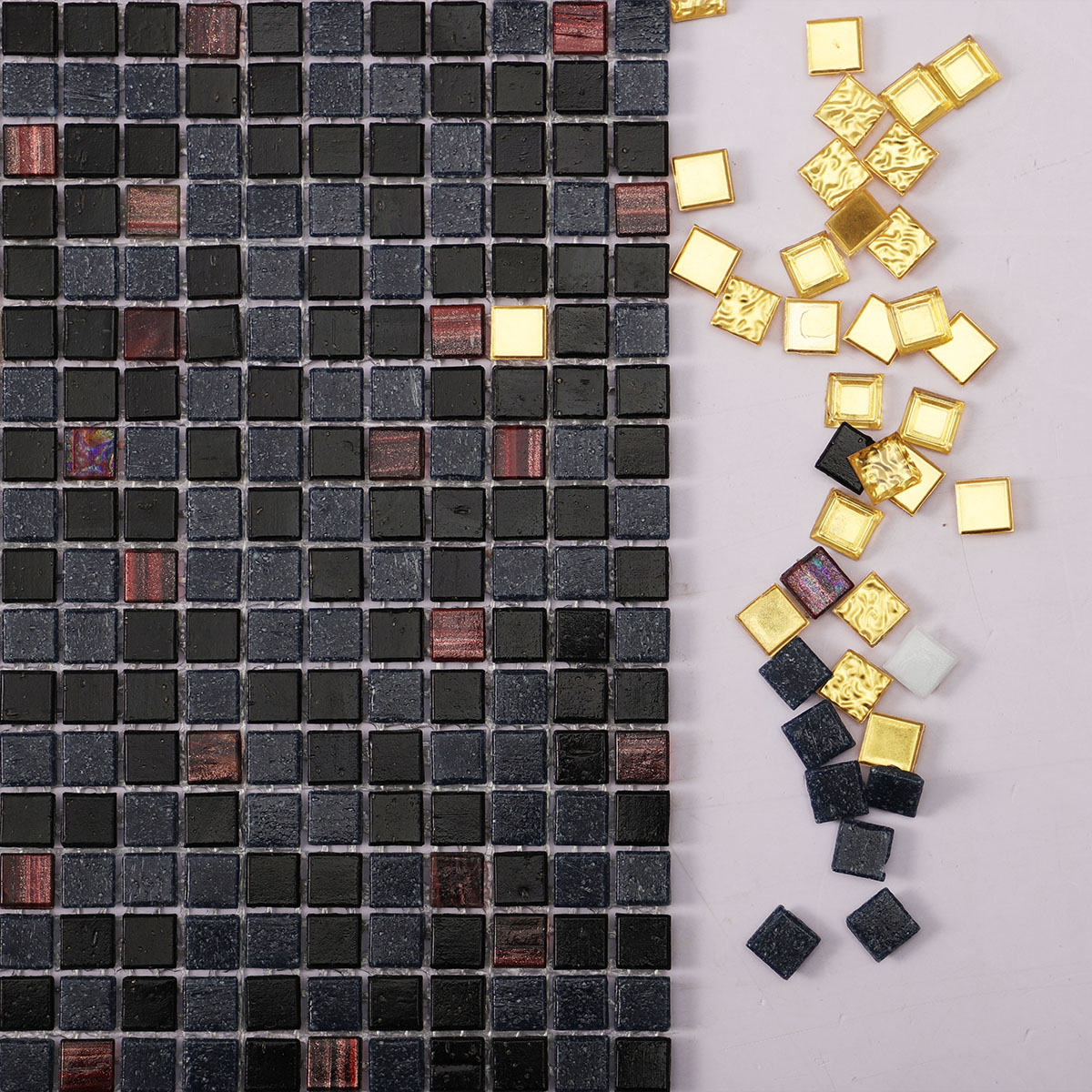 Close-up of black mixed glass micro mosaic tiles with gold.