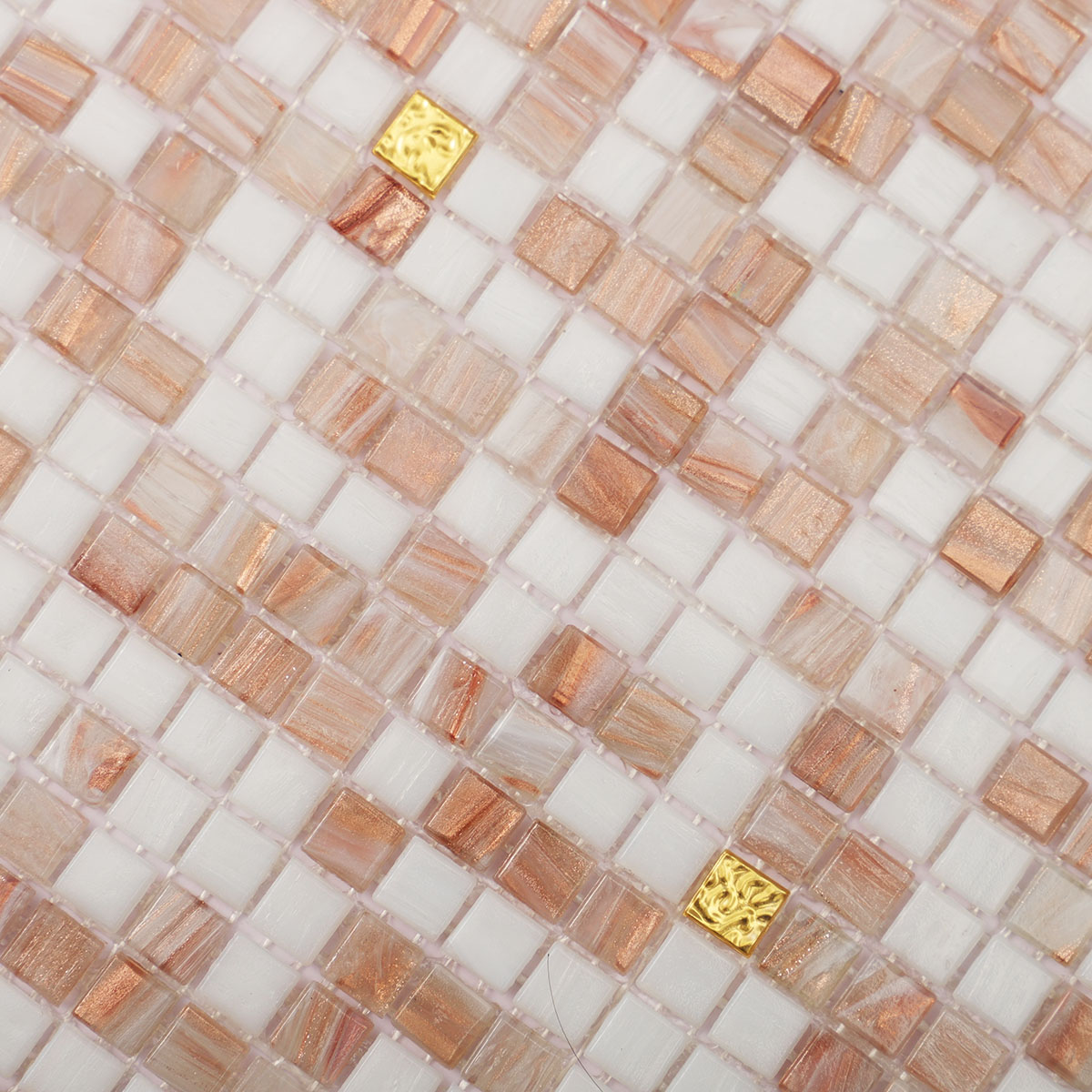 Detailed close-up of white and beige tiny glass mosaic tiles with 24K gold.