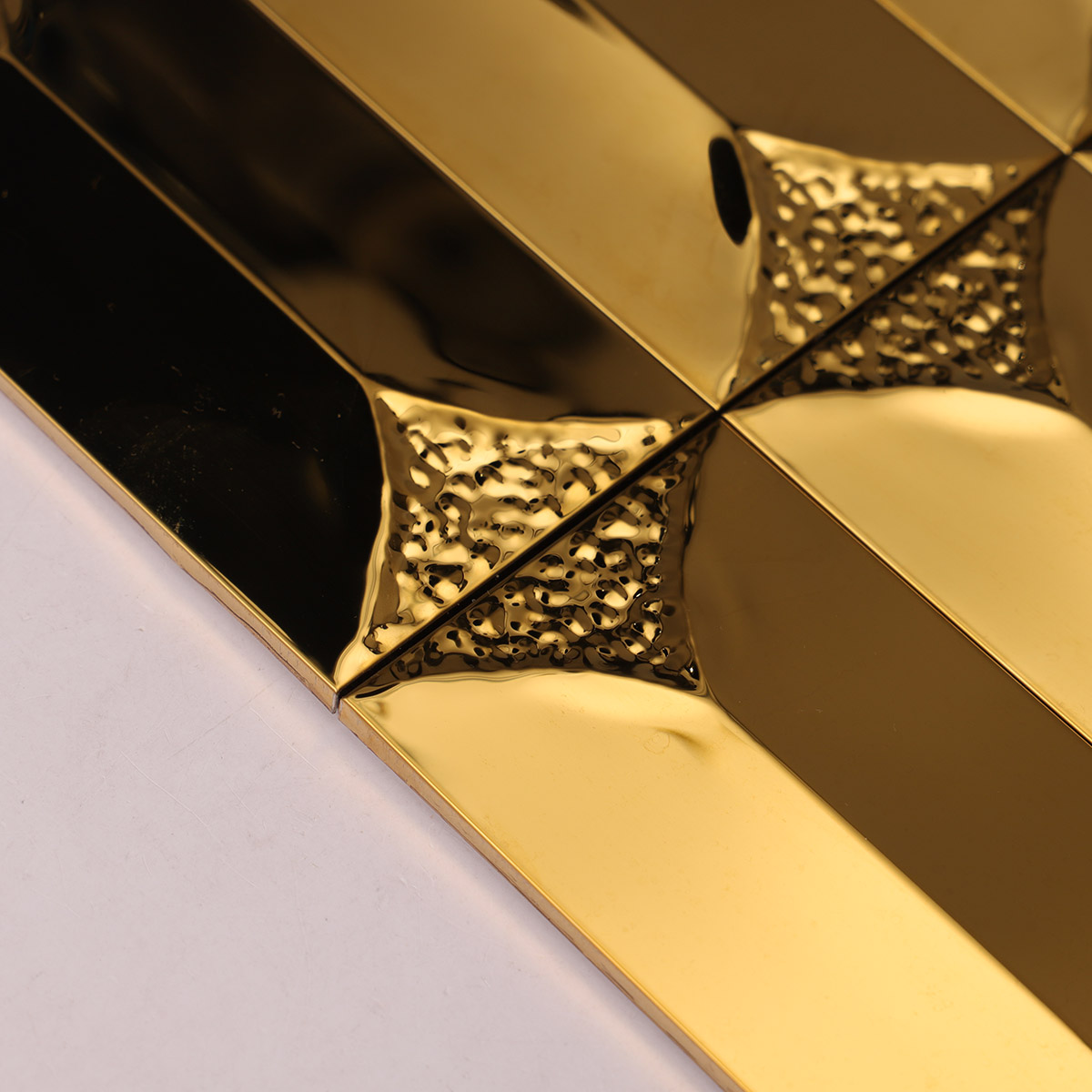 Close-up view  of gold rectangle 3D metal mosaic tile.