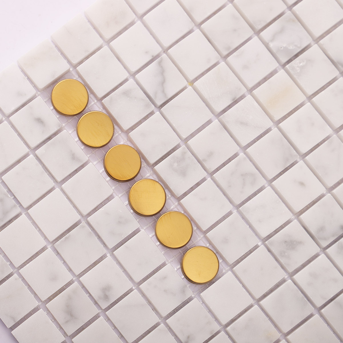 Close-up of white marble mixed metal mosaic tiles