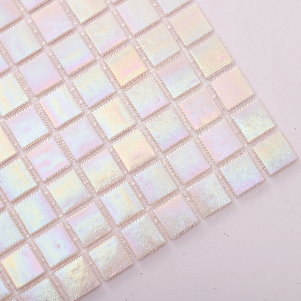 Detailed close-up of pearly iridescent pink square glass mosaic