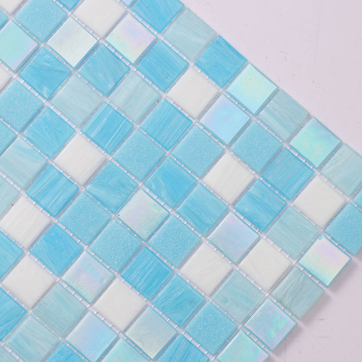 Side close-up of glossy aqua blue glass mosaic tiles
