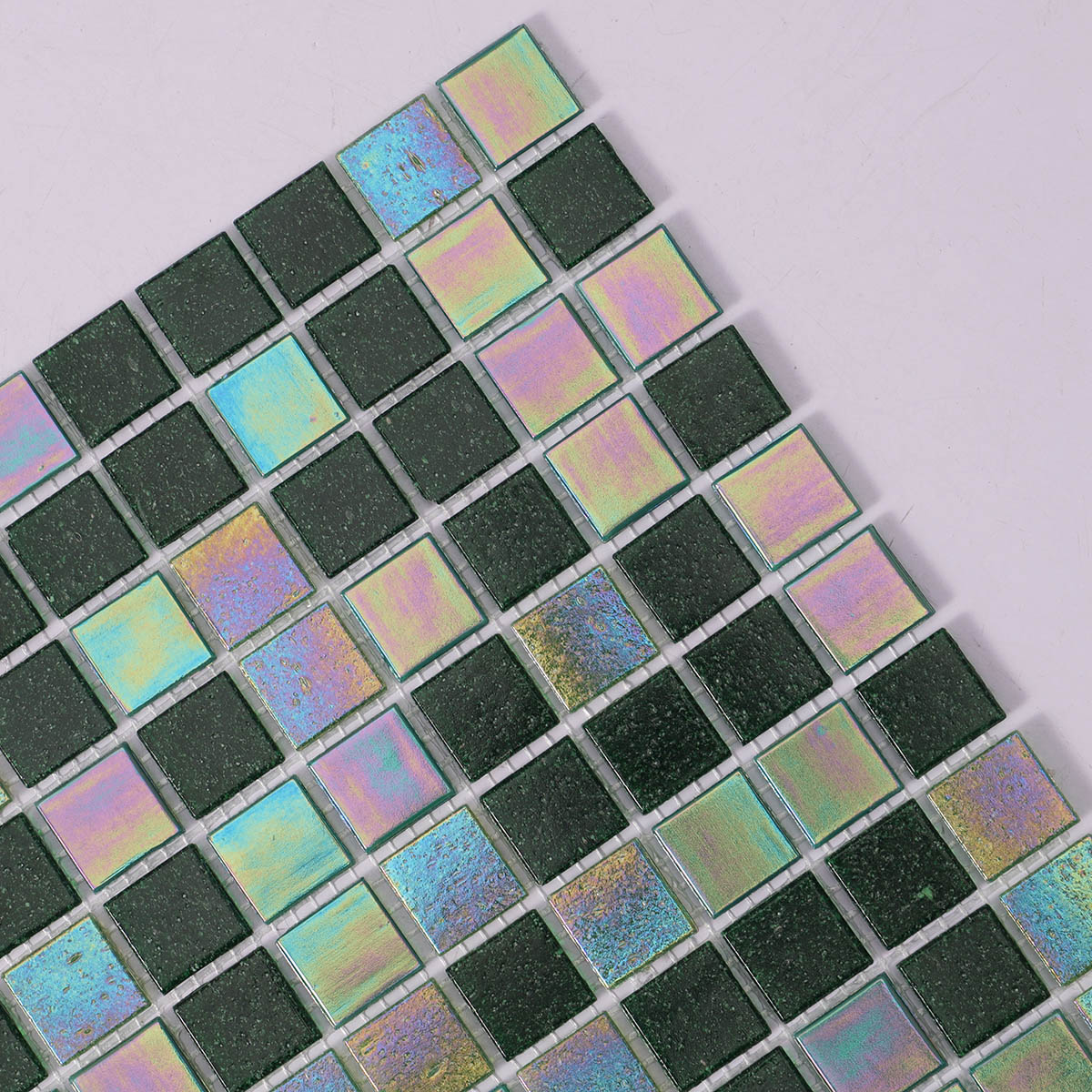 Detailed close-up of iridescent green square glass mosaic tiles