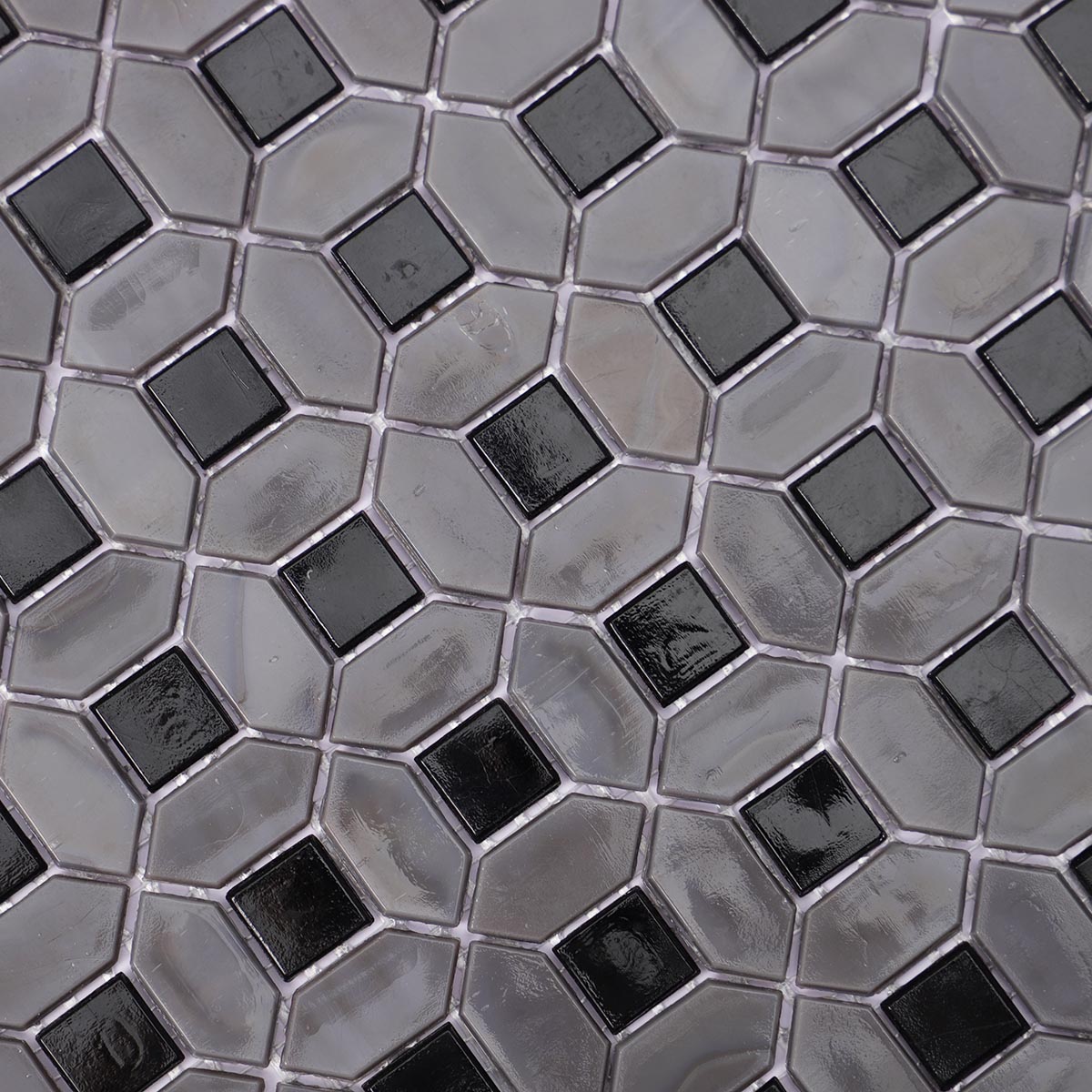 Close-up of gray picket and black square glass mosaic tiles