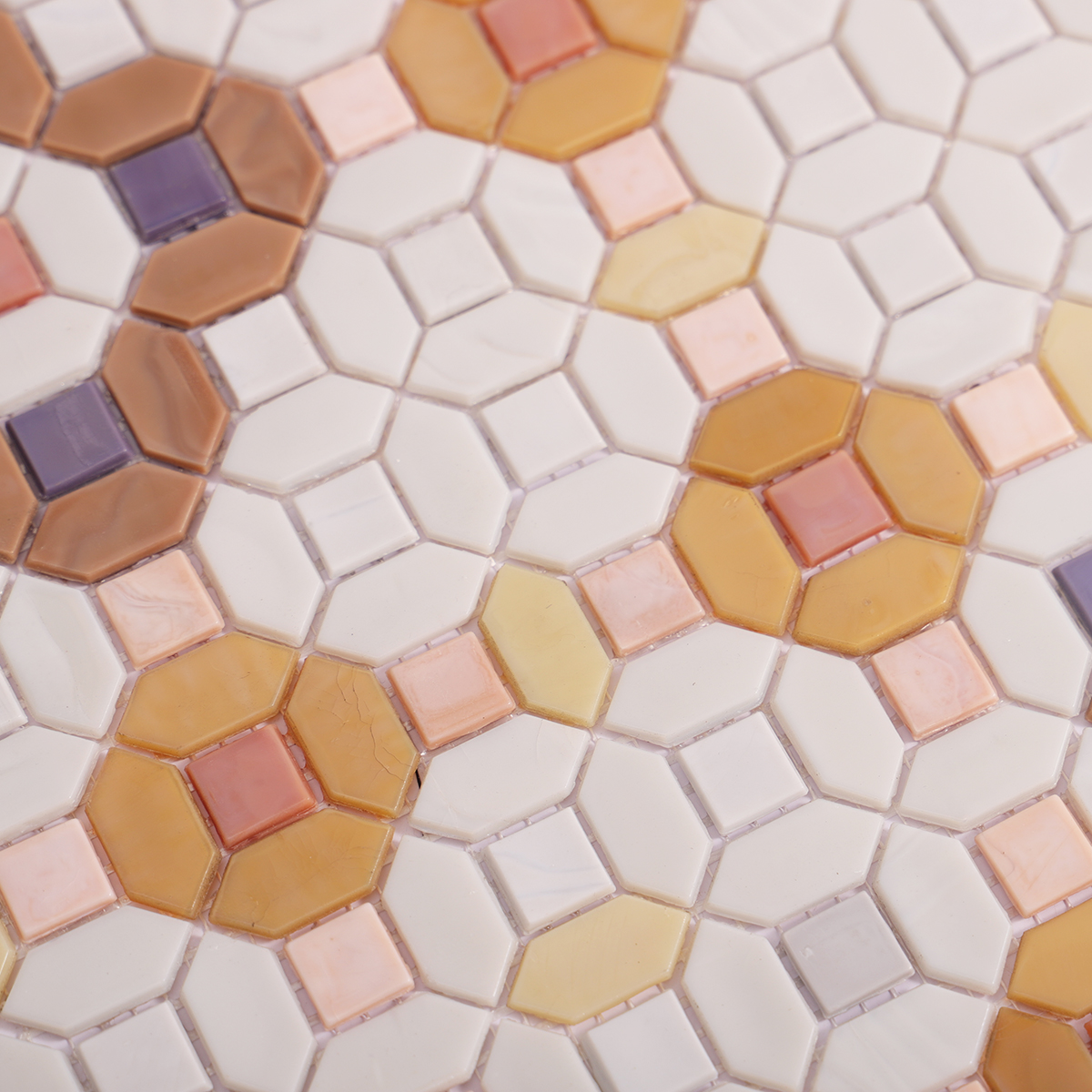 Close-up of floral orange and white glass mosaic tiles
