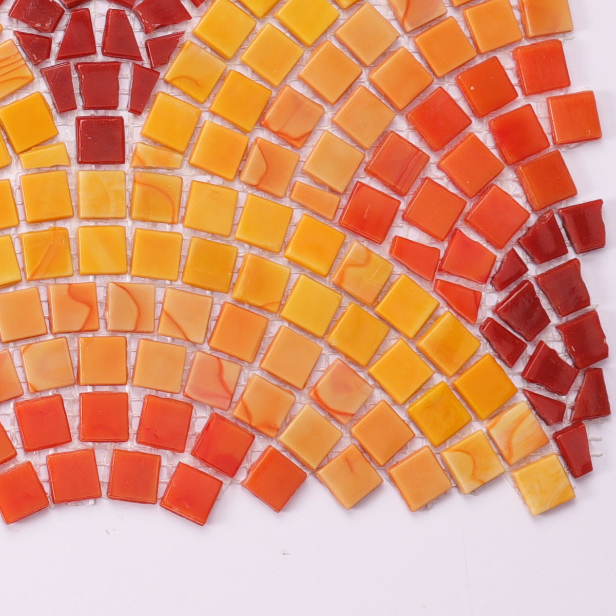 Detailed close-up of orange and red glass mural mosaic for wall art