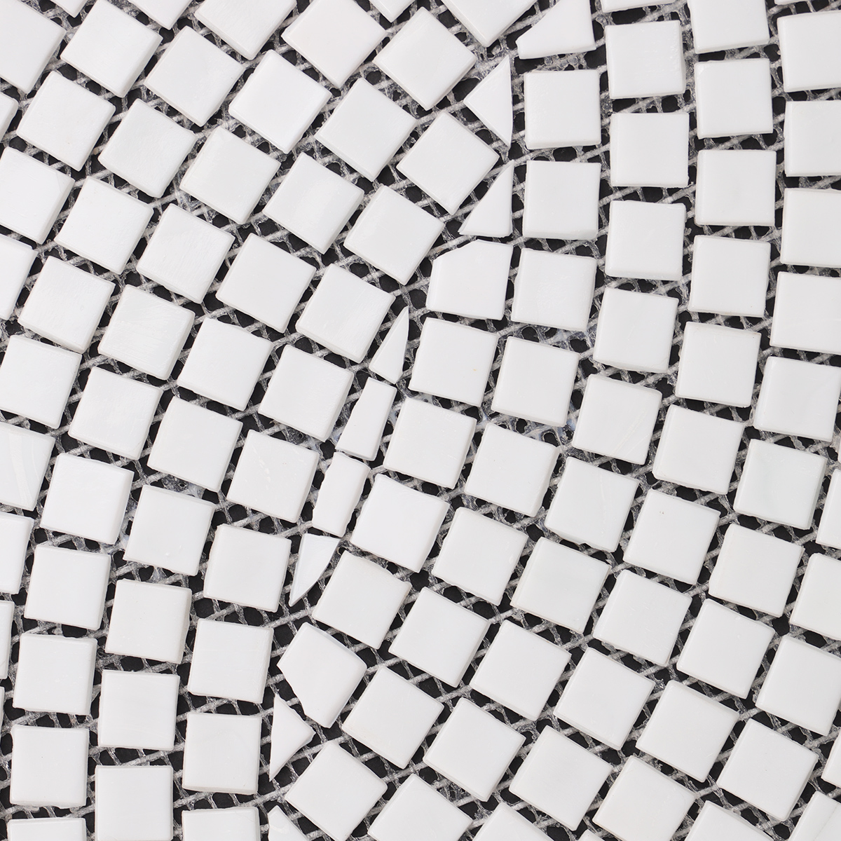 Close-up of white glass mosaics with hand-cutting art