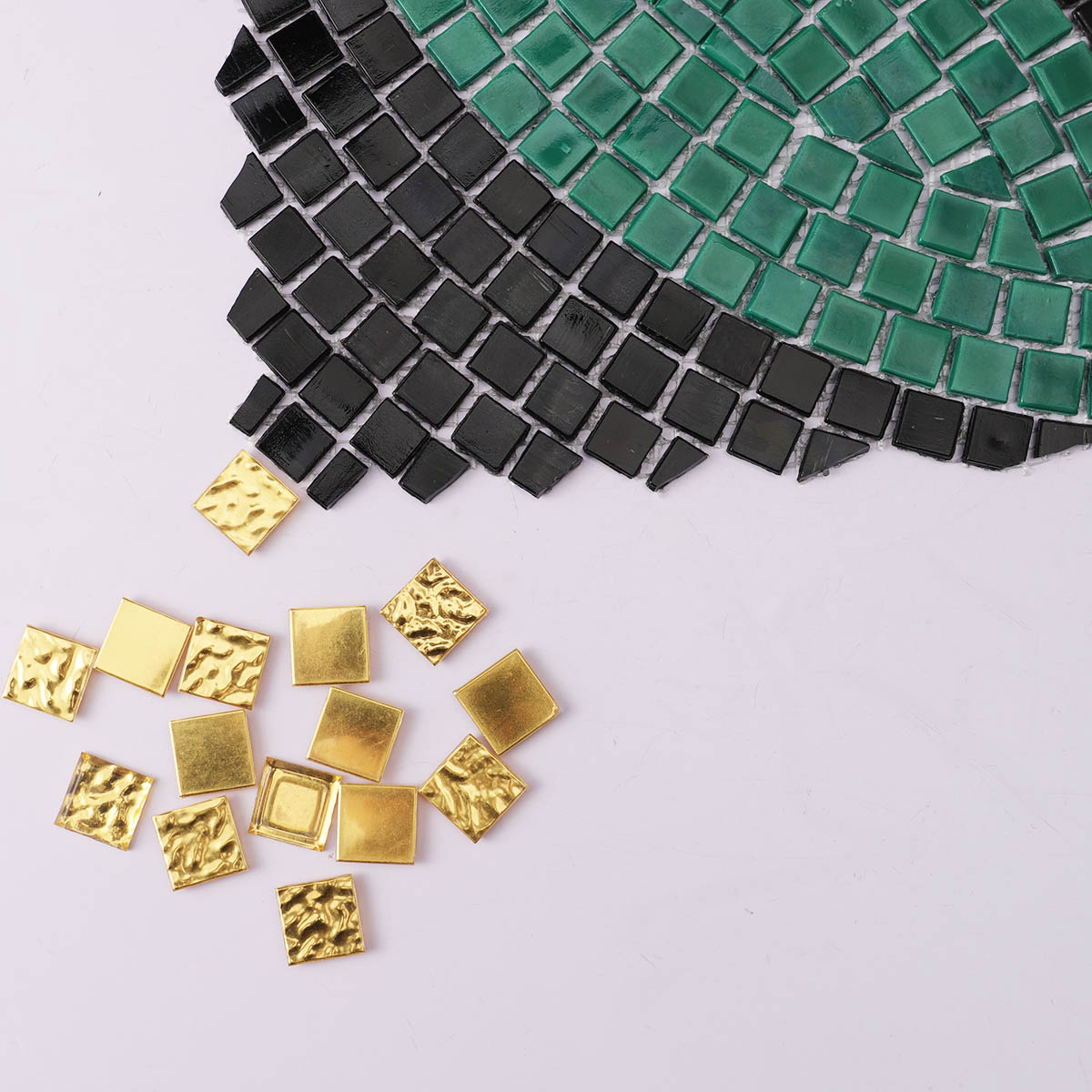 Close-up of glass mosaic tiles with hand-cut art patterns, combined with 24K gold mosaic tiles