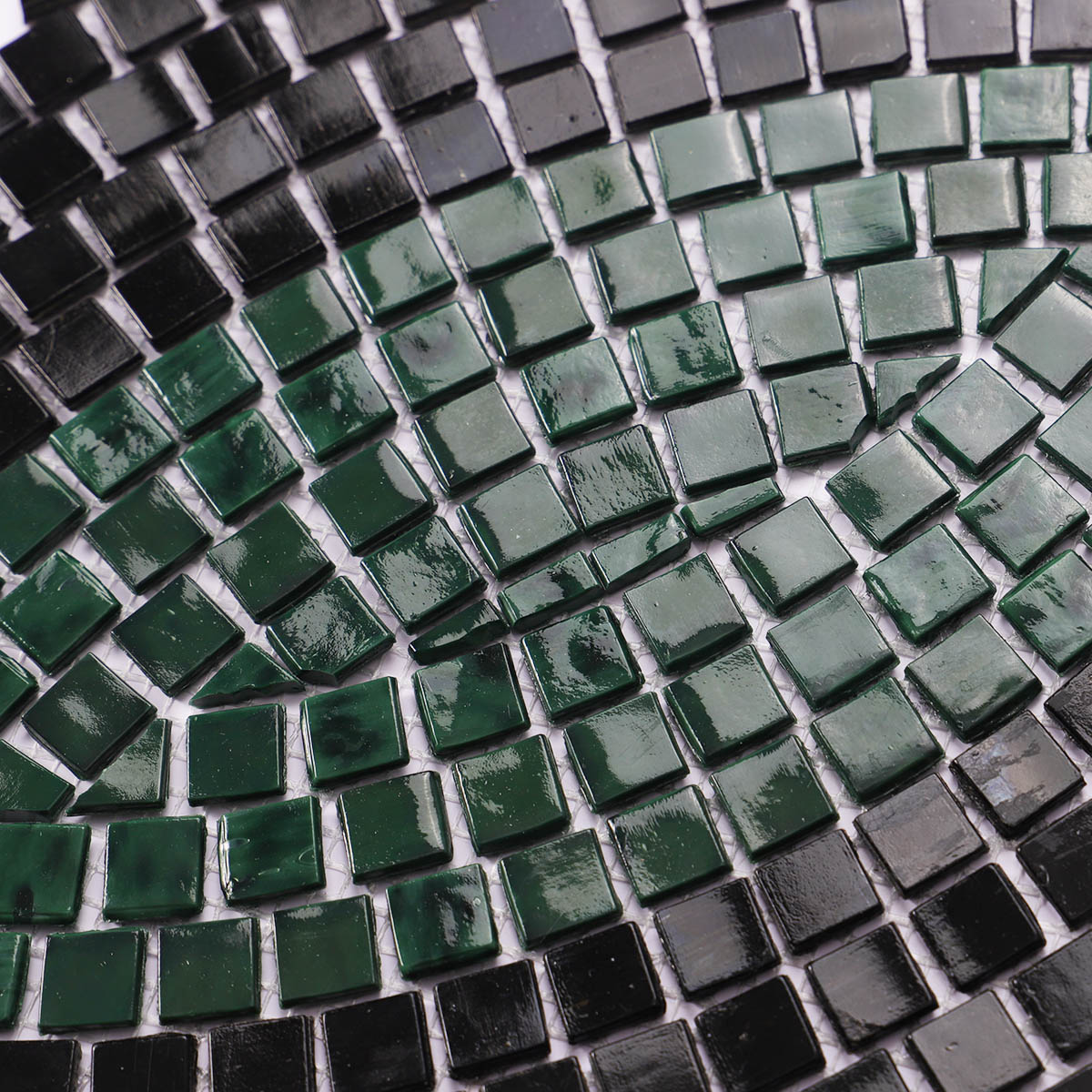 Green and black glass mosaic pattern wall art close-up