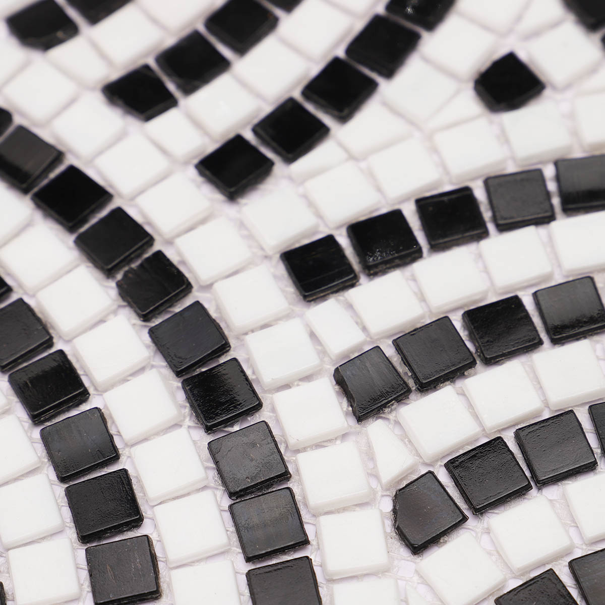 Detailed close-up of white and black scale glass mosaic tiling art