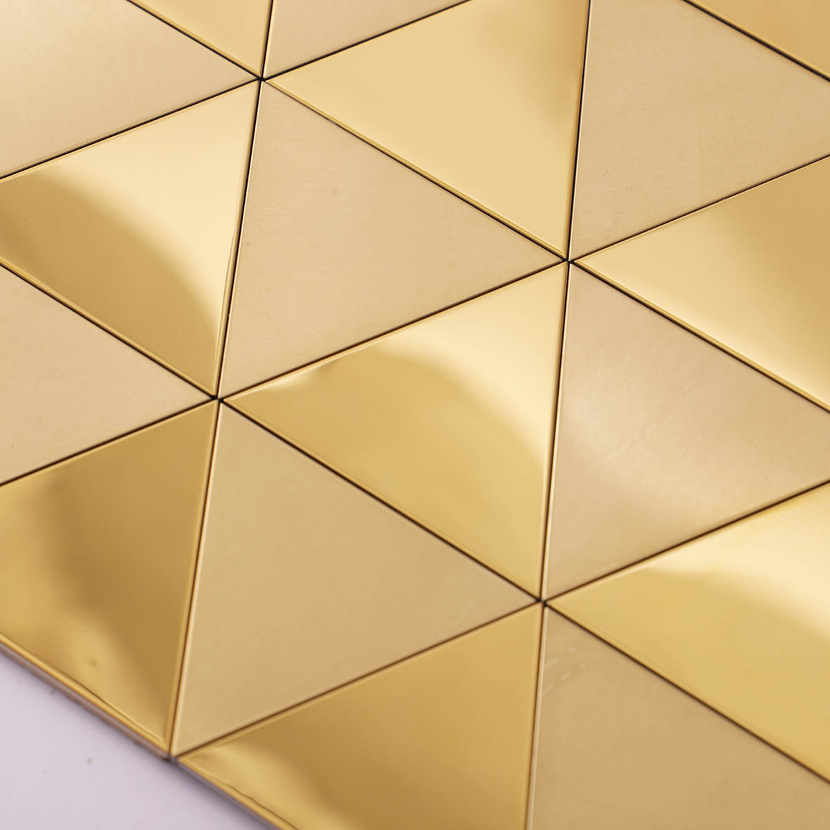 Close-up of gold triangle metal mosaic wall tiles