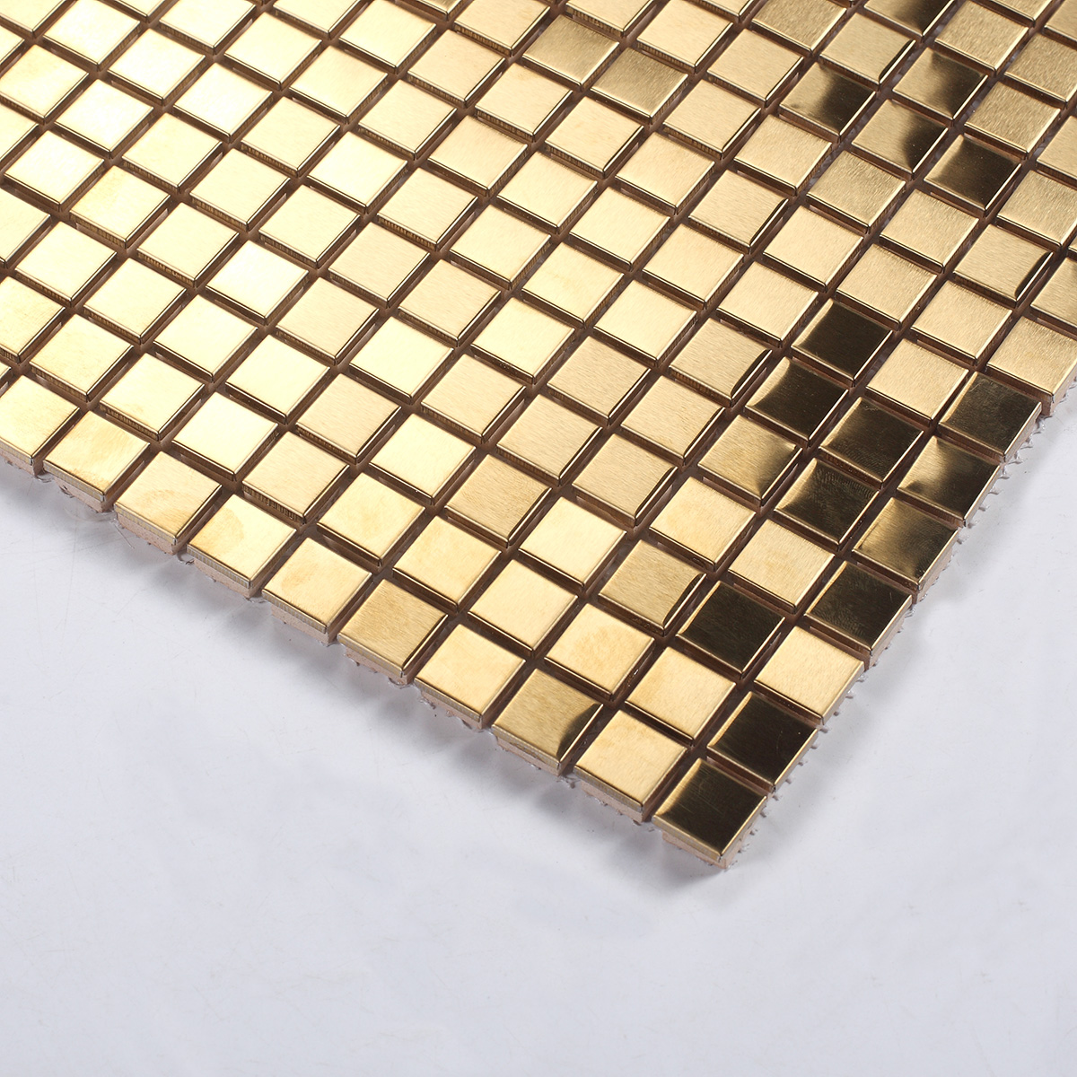 Close-up of metallic gold square mosaic wall tiles