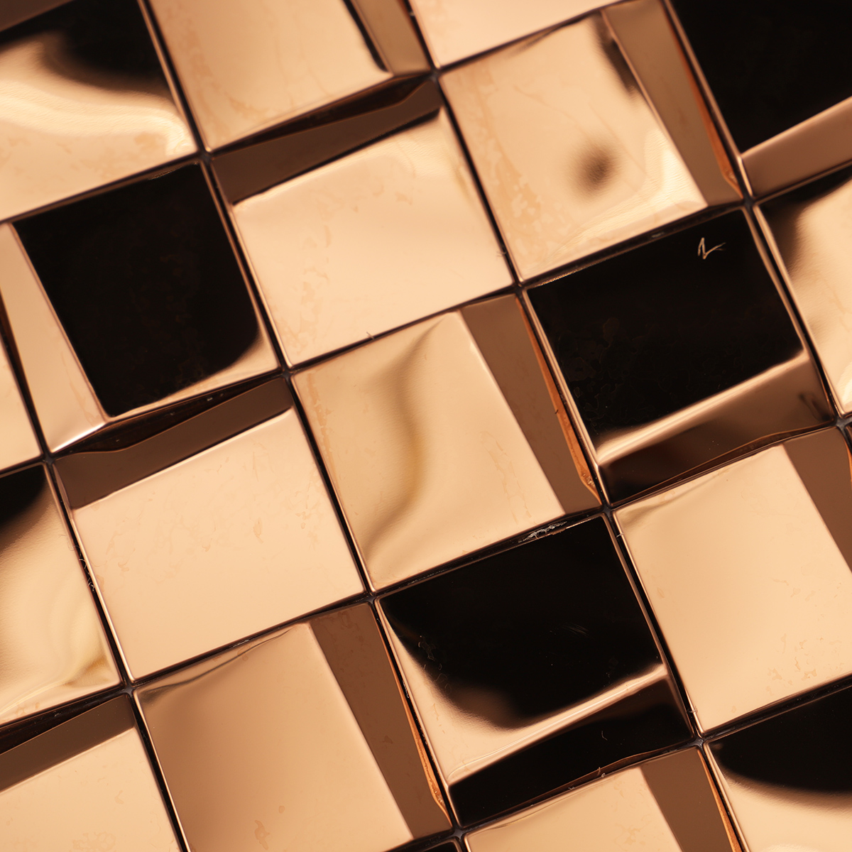 Detailed close-up of mirror gold metal square mosaic tiles.