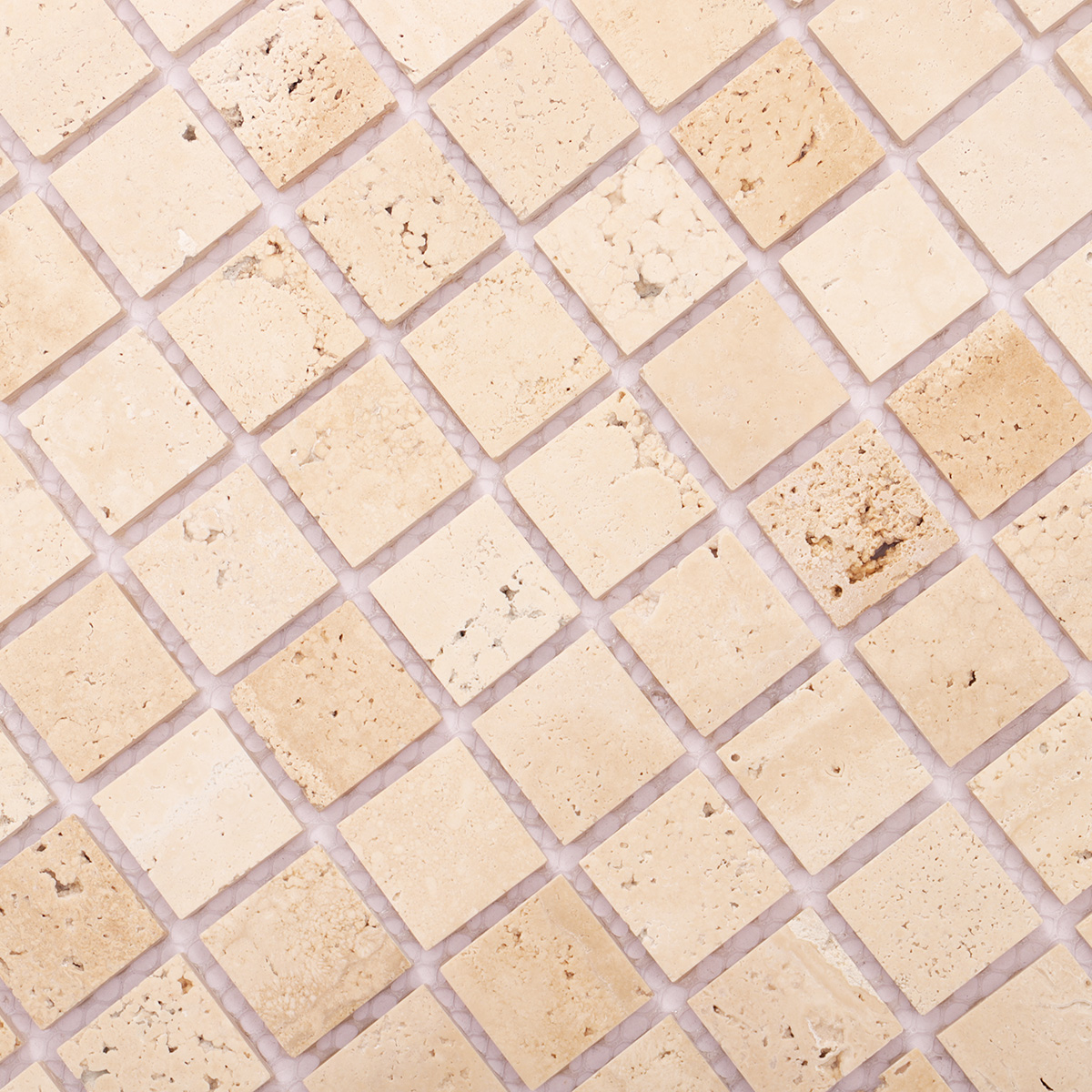 Close-up view of light honed square mosaic travertine.
