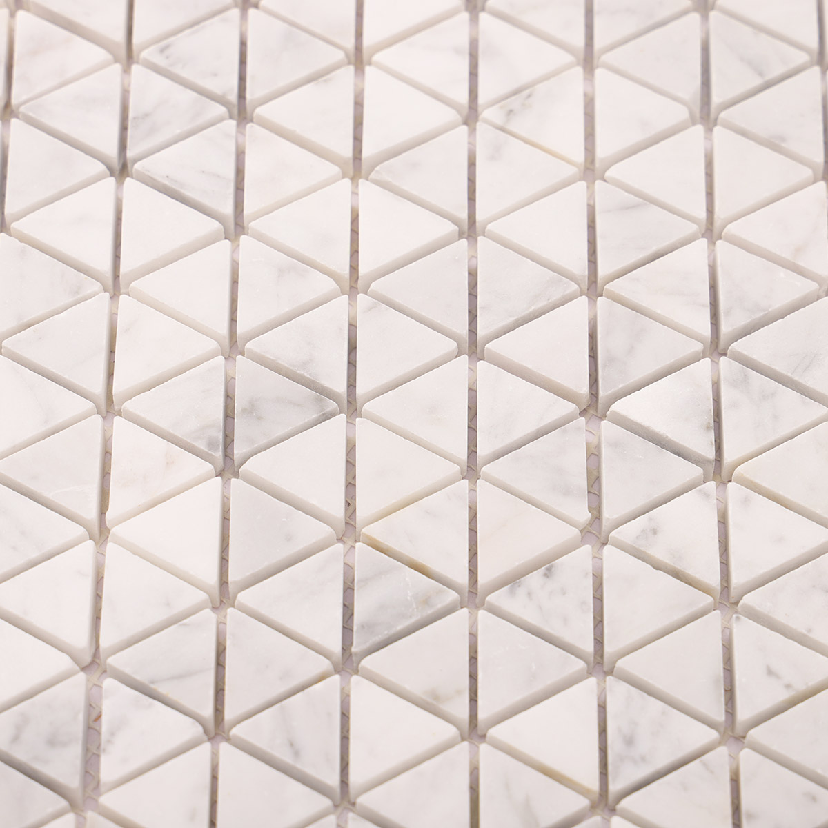 Close-up of Carrara white geometric triangle marble mosaic tiles.