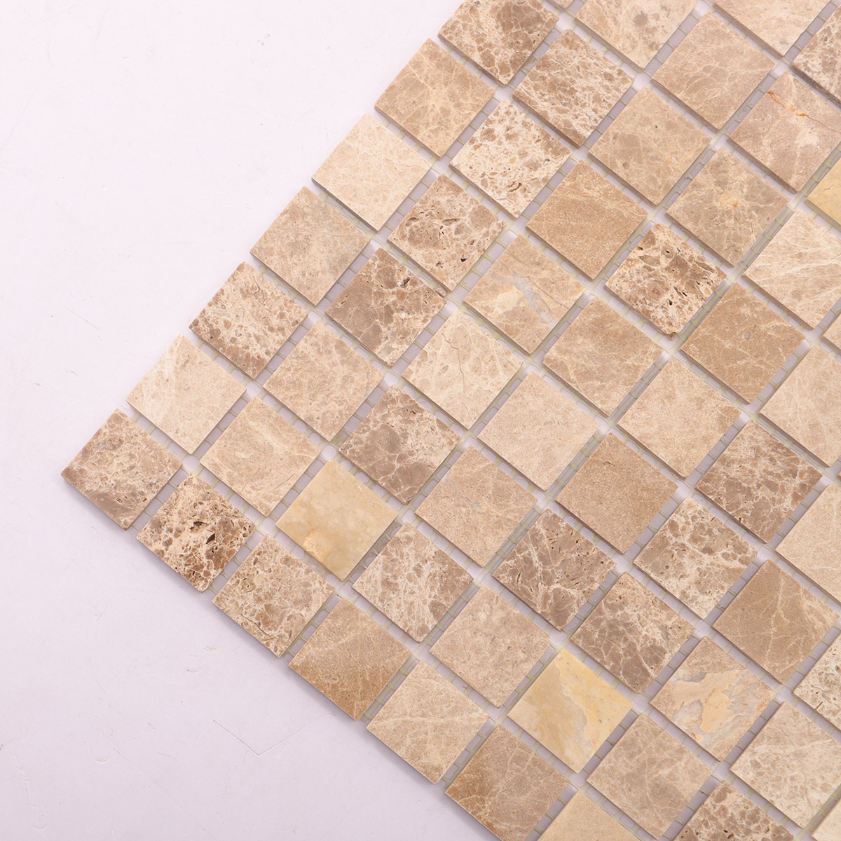 Detailed close-up of Emperador light polished marble mosaic tiles.