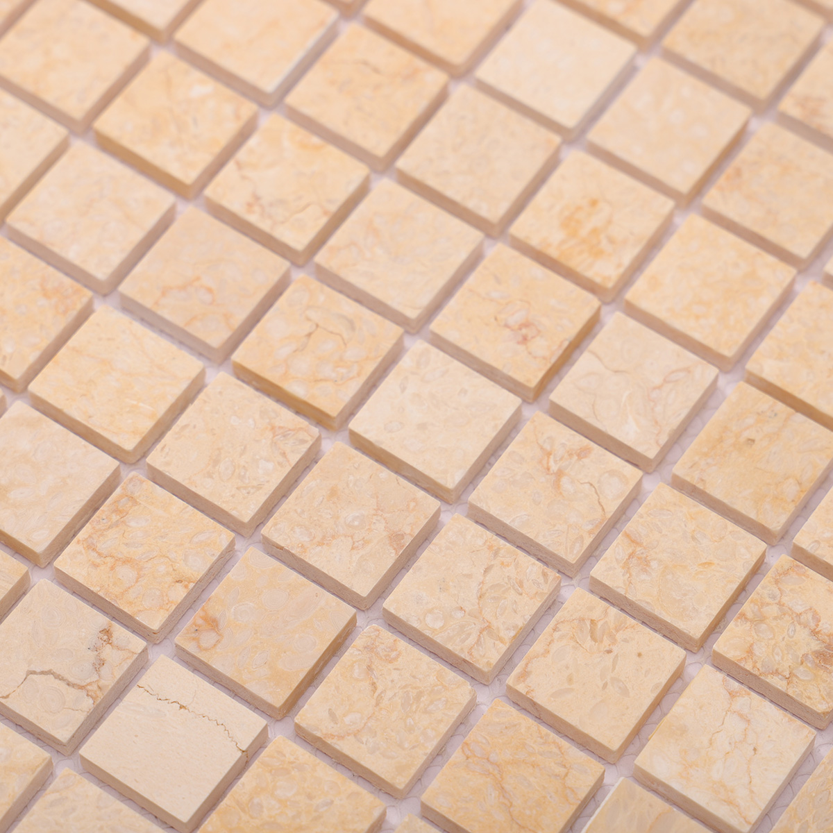 Close-up view of Crema Marfil square marble mosaic tiles.