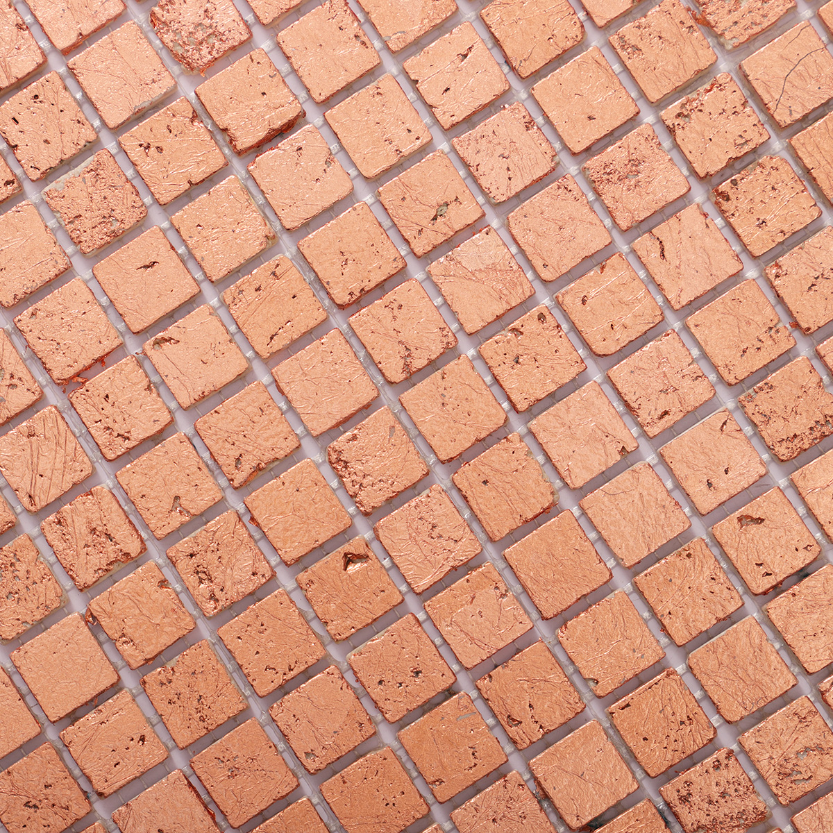 Detailed close-up of rose gold foil marble mosaic tiles.