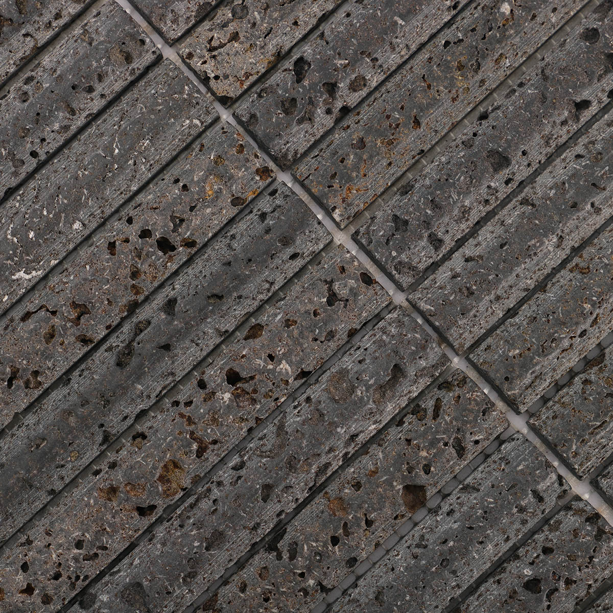 Close-up of 3D concave fluted strip black lava stone mosaic tiles.