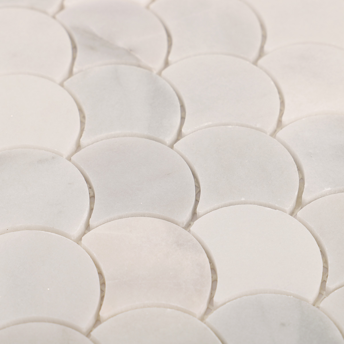 Close-up of fish scale white marble polished mosaic tiles.