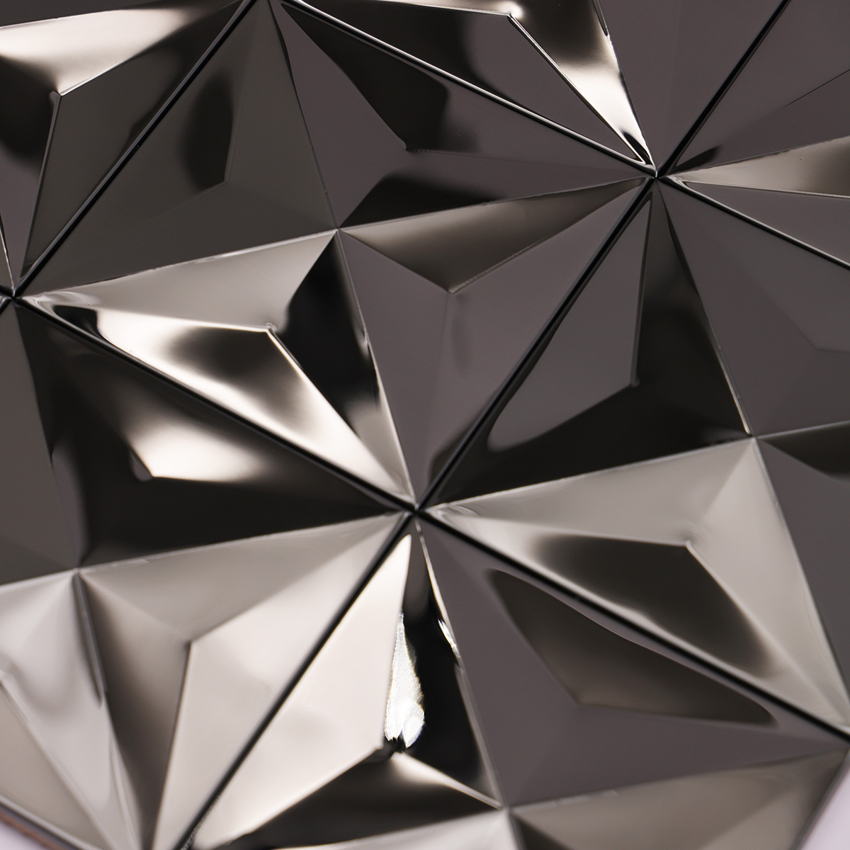 Detailed close-up of black 3D mirror metallic mosaic tiles.