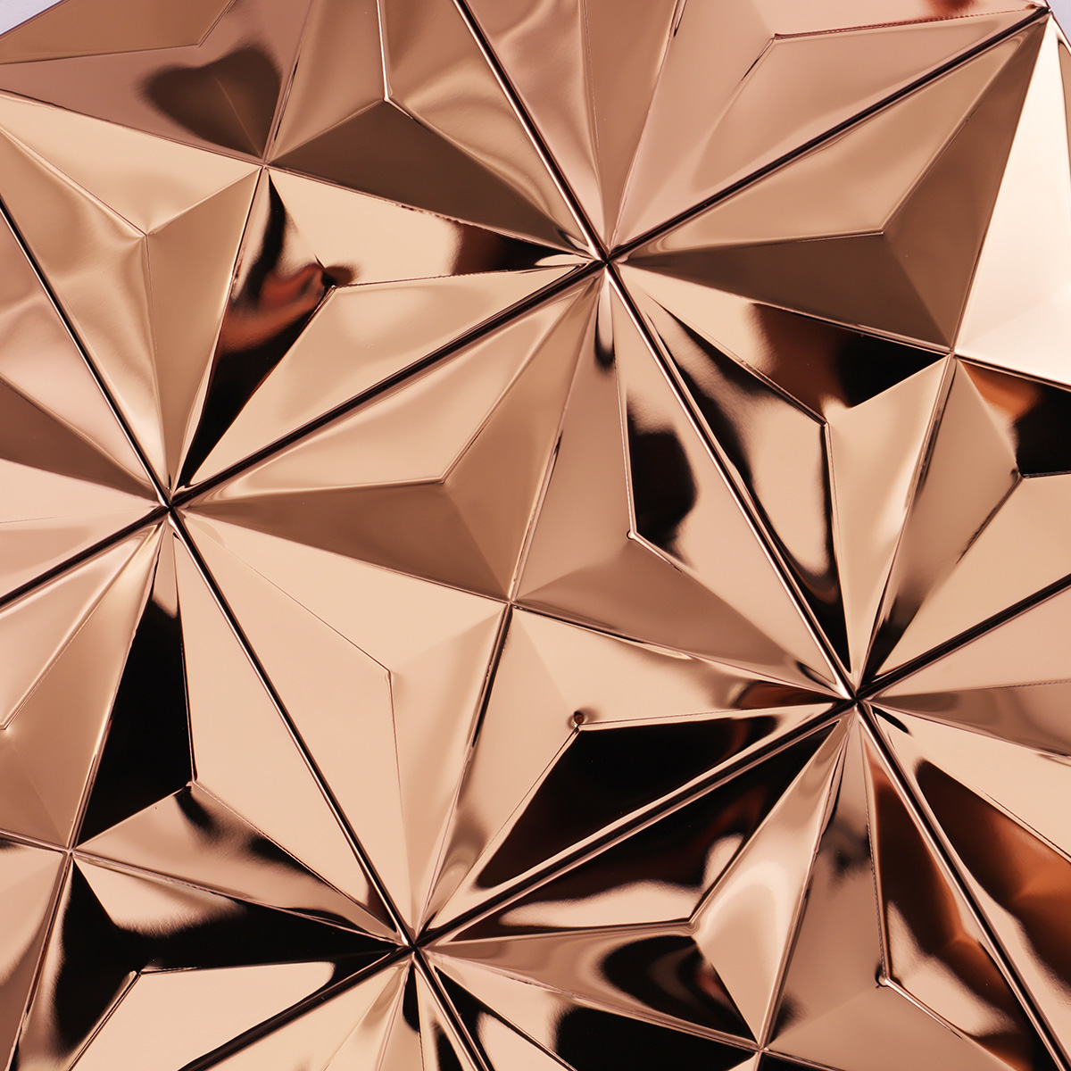 Detailed close-up of rose gold 3D stainless steel metal mosaic tiles.