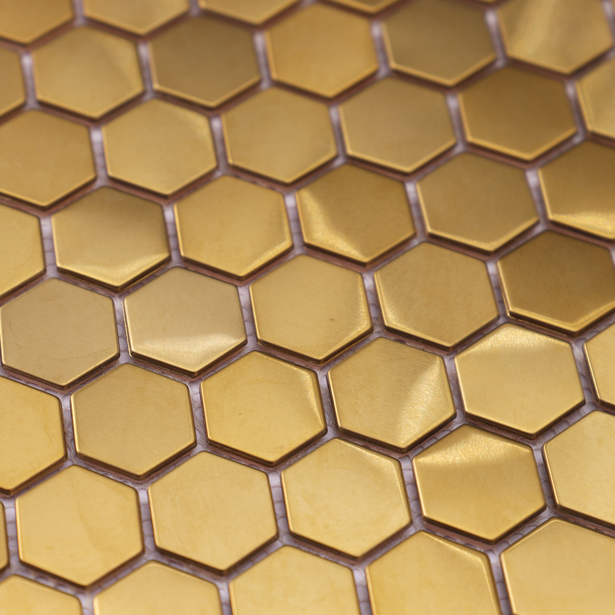 Detailed close-up of hexagon gold brushed mirror stainless steel mosaic tiles.
