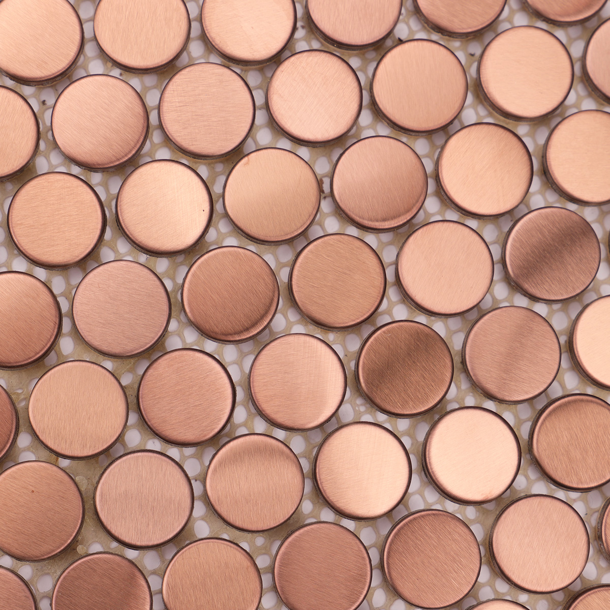 Detailed close-up of rose gold penny rounds stainless steel metal mosaic tiles.
