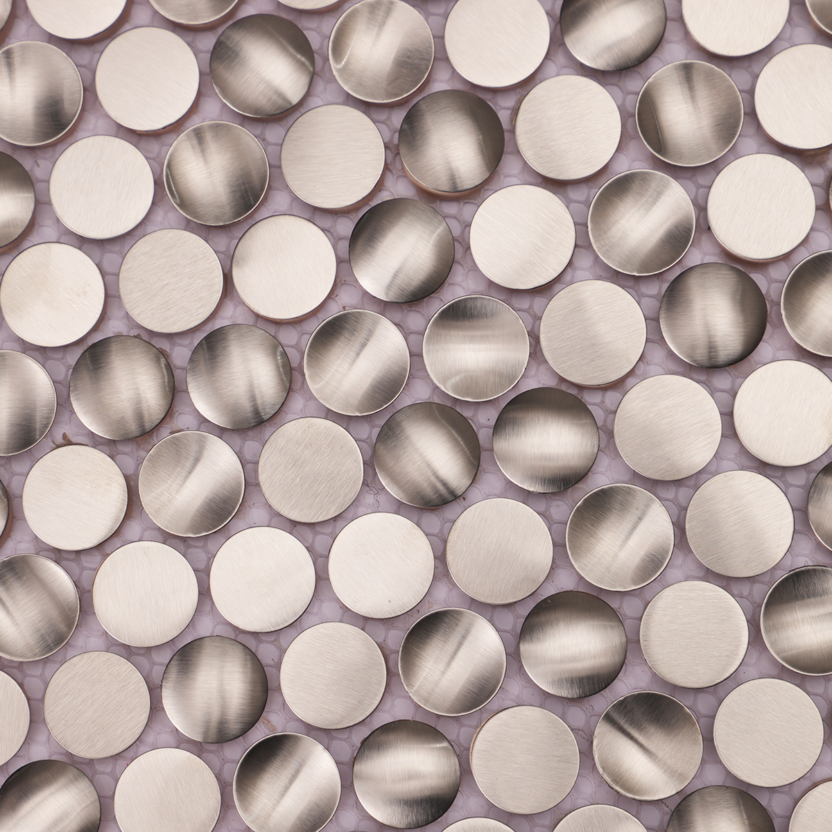Close-up of 3D penny round silver stainless steel mosaic tiles.