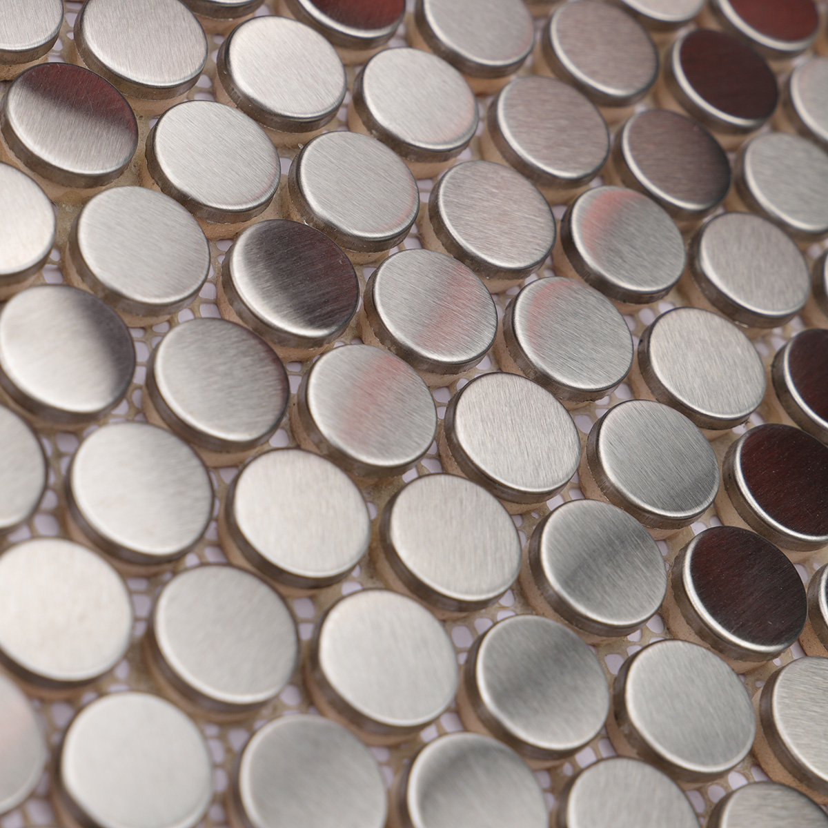 Close-up of brushed silver penny rounds metal mosaic tiles.