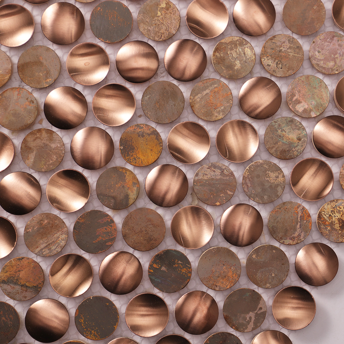 Close-up of penny rounds stainless steel and copper mosaic tiles.