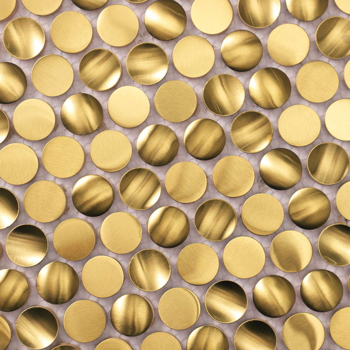 Close-up of 3D gold penny rounds brushed stainless steel mosaic tiles.