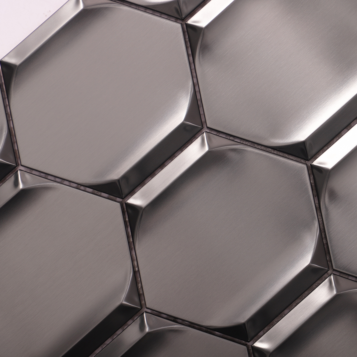 Close-up of 3D black hexagon metal mosaic tiles.