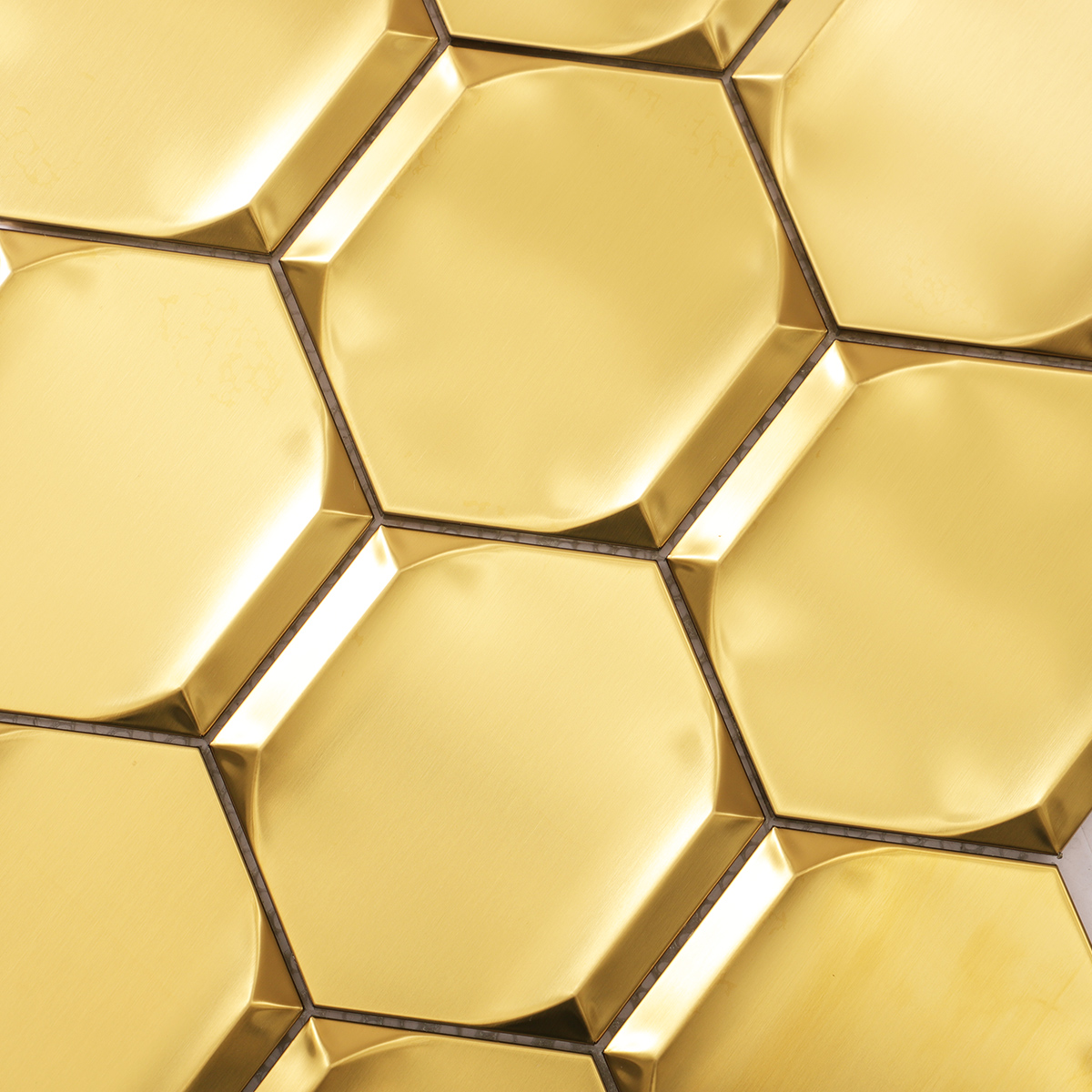 Close-up of big hexagon gold 3D stainless steel metal mosaic tiles.
