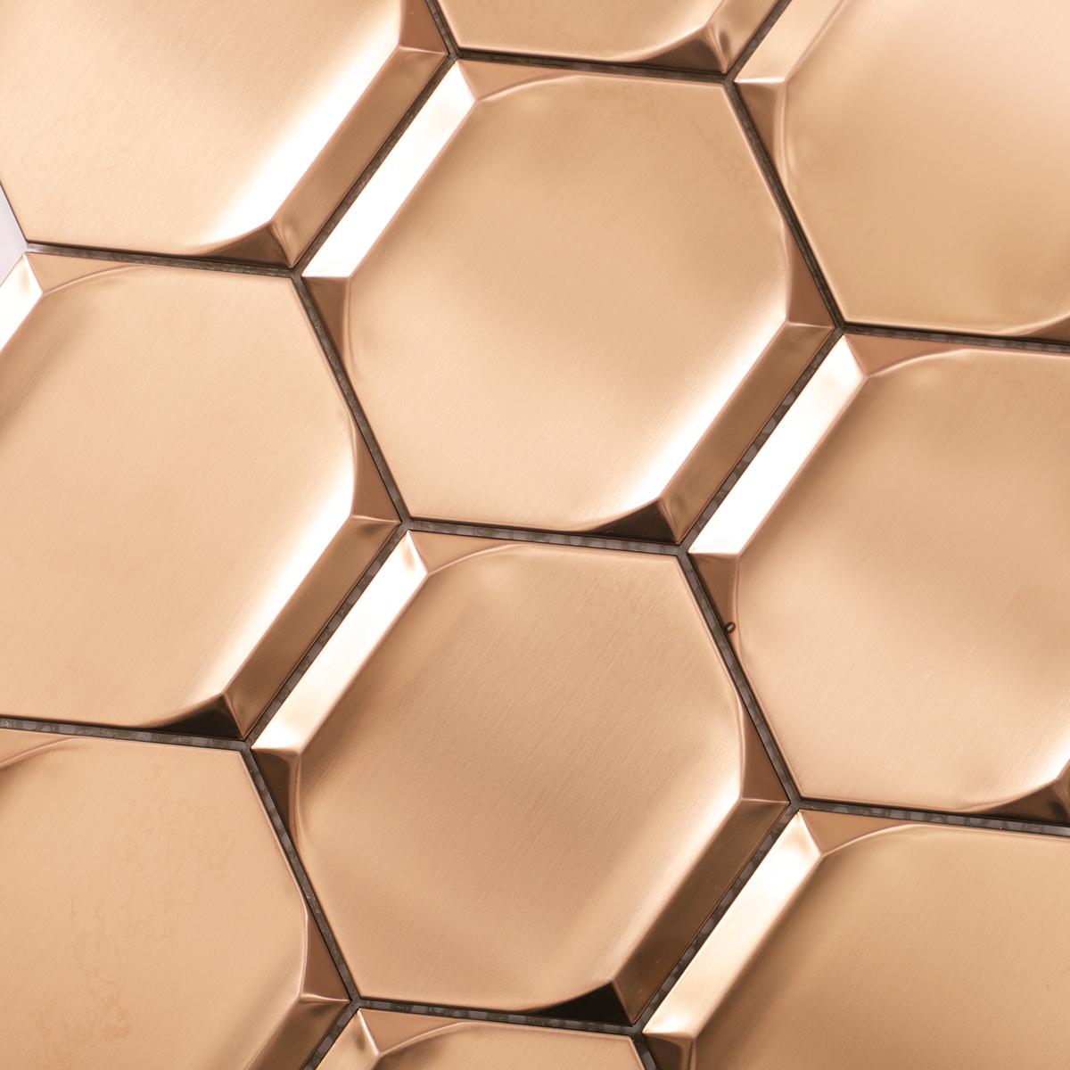 Detailed close-up of rose gold 3D stainless steel hexagon mosaic tiles.