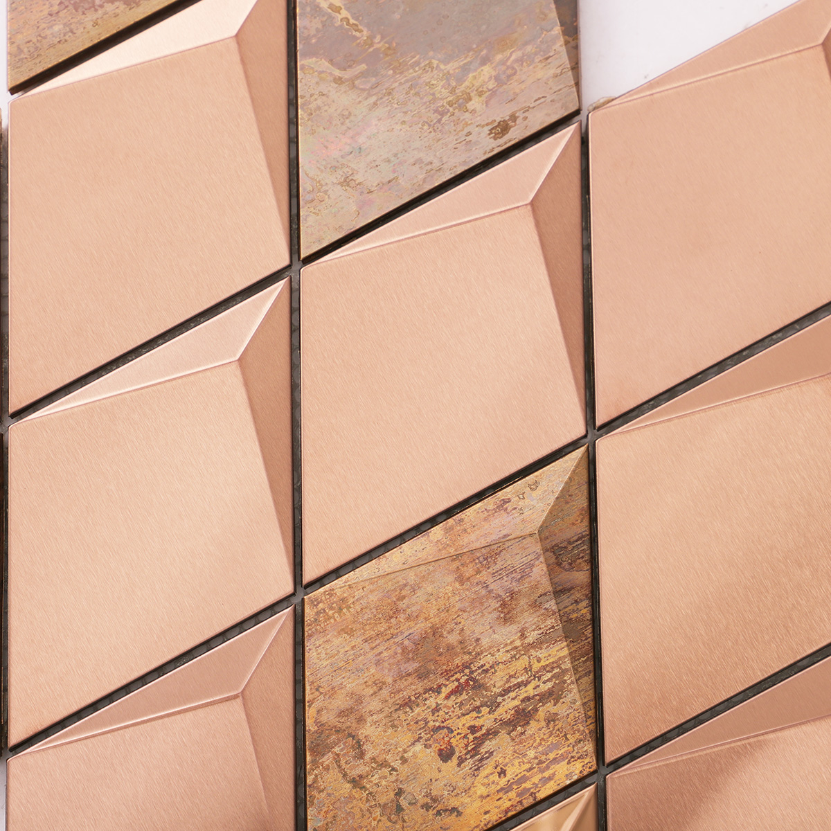 Detailed close-up of 3D diamond stainless steel and copper mosaic tiles.