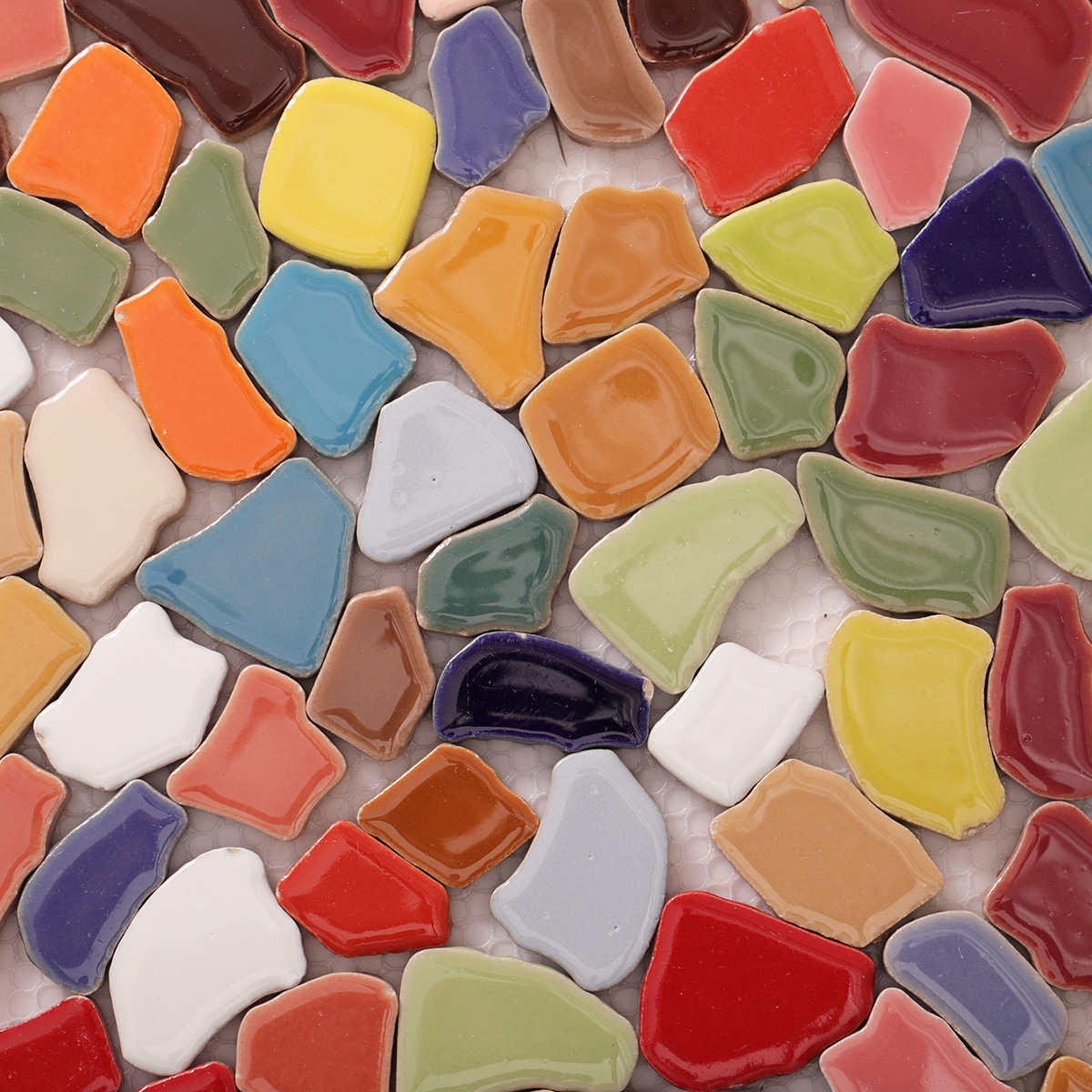 Detailed close-up of colorful broken ceramic mosaic tiles