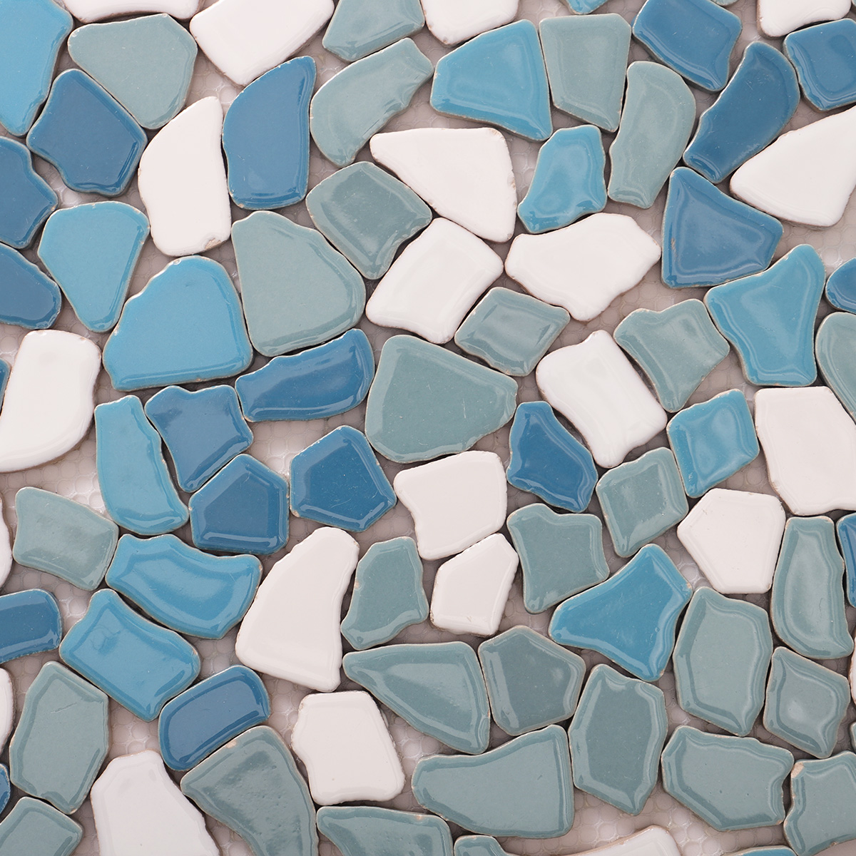 Detailed close-up of irregular broken ceramic pebble mosaic tiles.