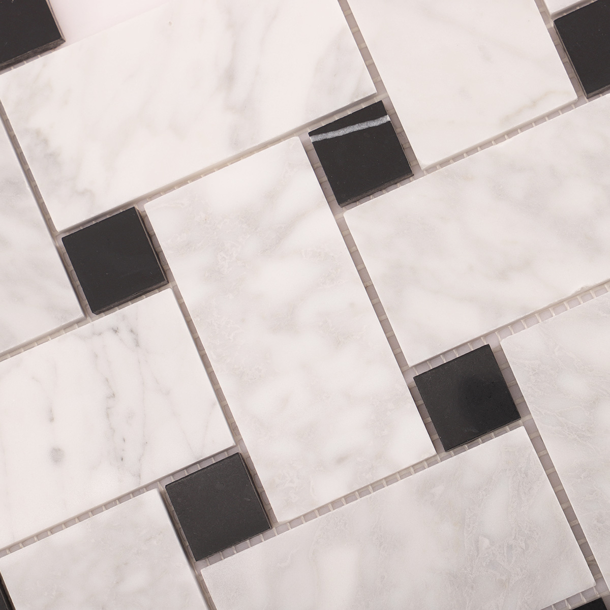 Close-up of Carrara white basketweave marble mosaic tiles
