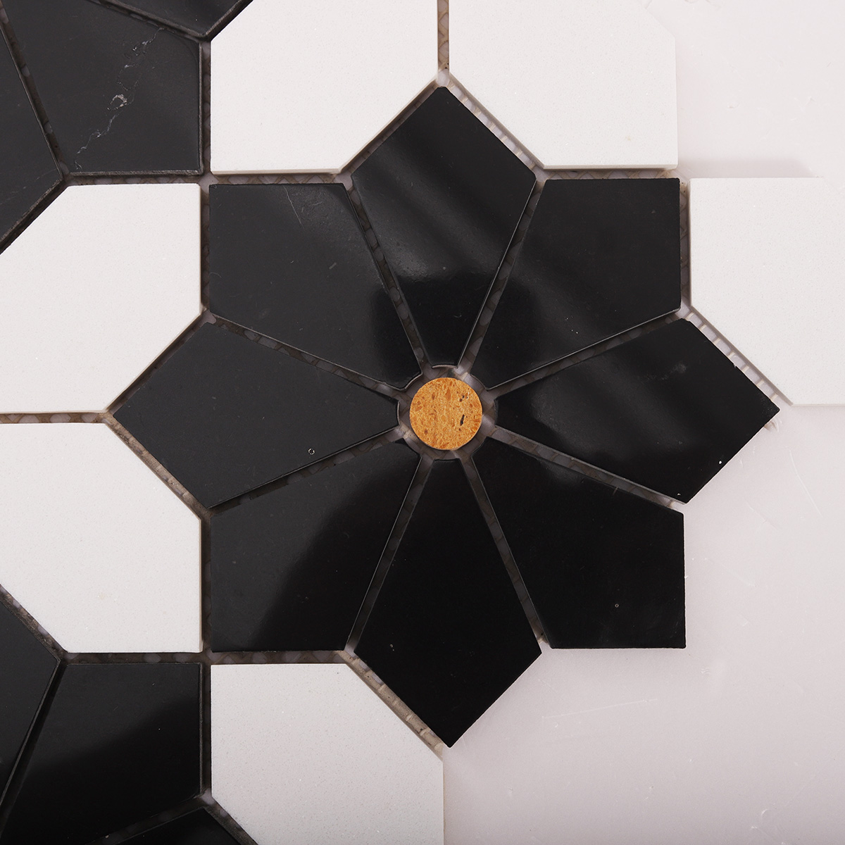 Close-up view of white and black floral marble mosaic tiles