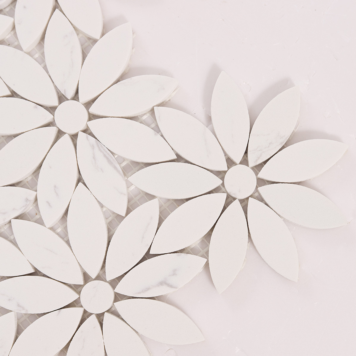 Close-up view of white daisy waterjet marble mosaic tiles