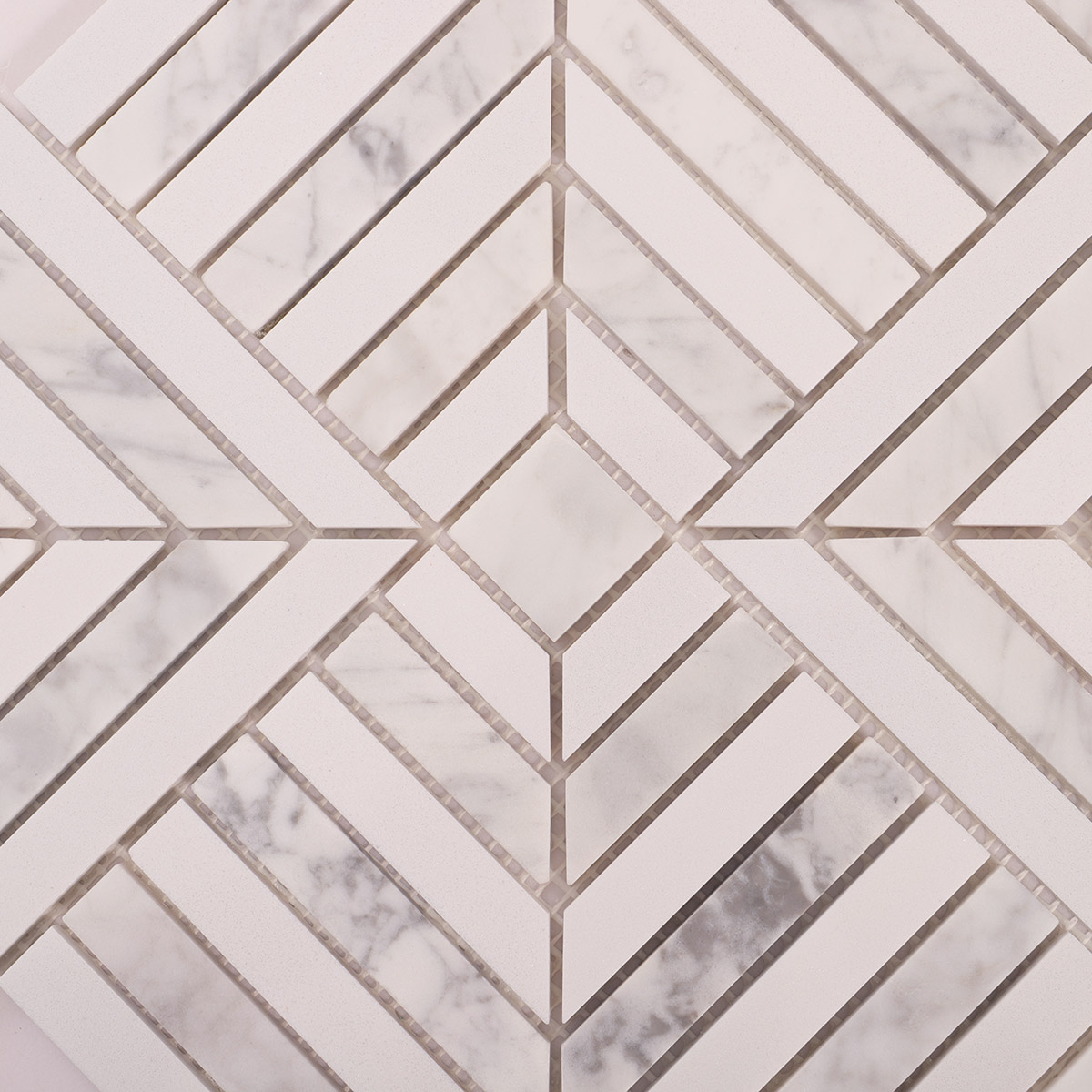 Detailed close-up of white geometric marble mosaic tiles