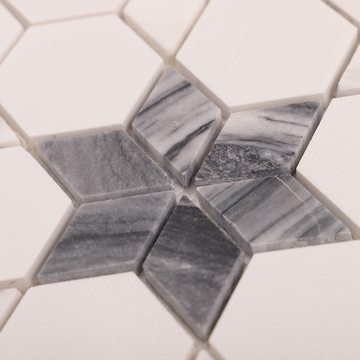 Close-up of white and grey flower marble mosaic tiles.