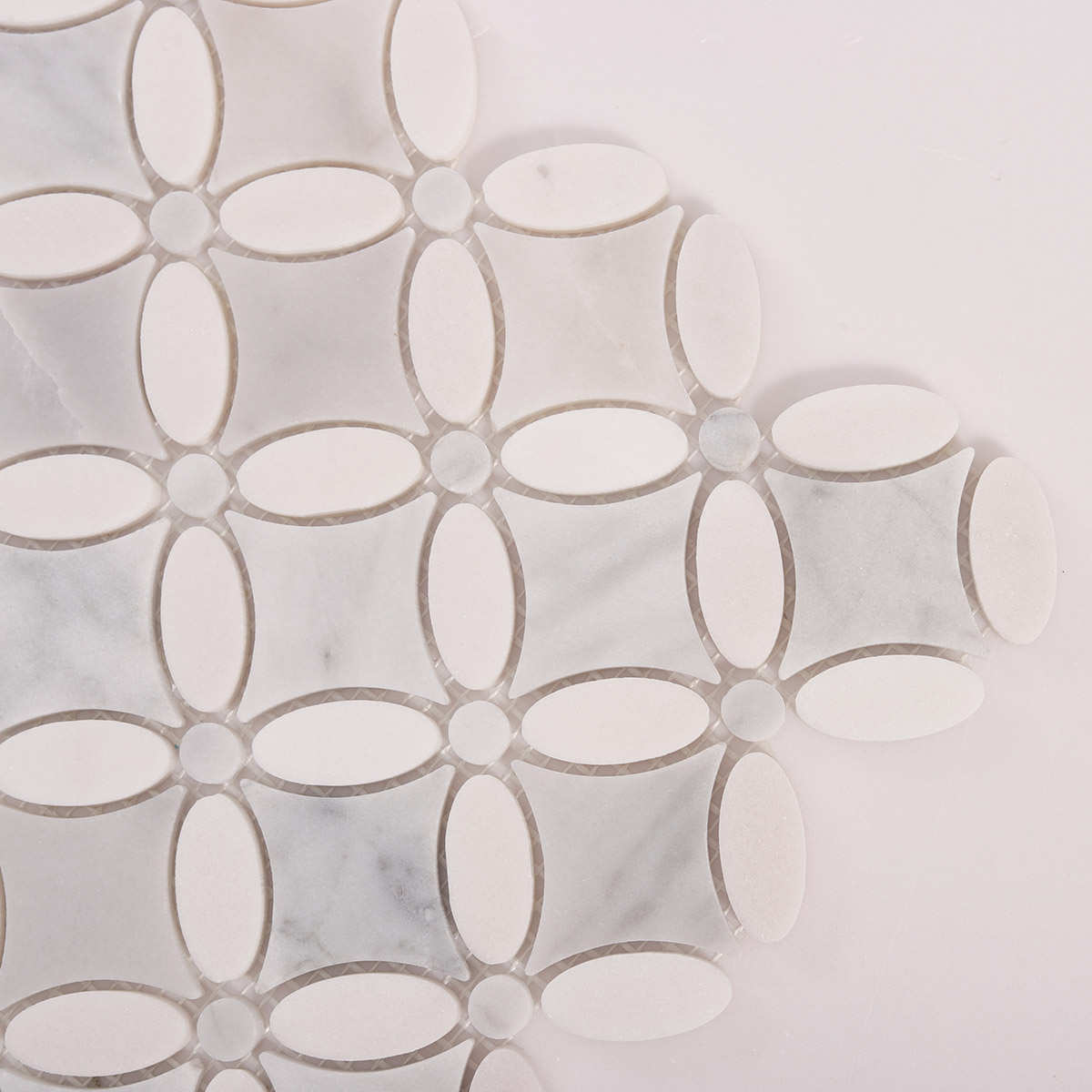 Detailed close-up of Carrara white flower marble mosaic tiles