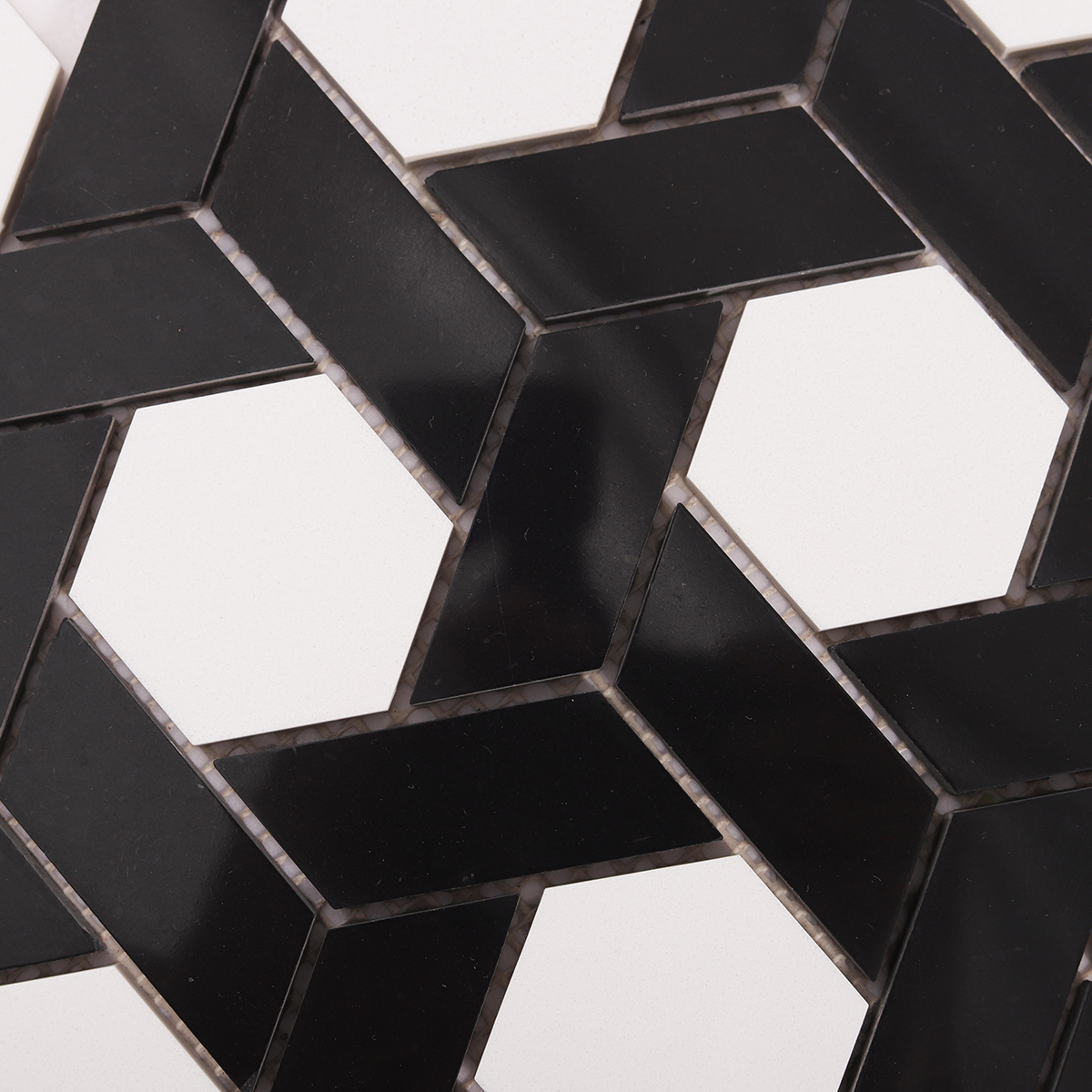 Macro close-up of white and black lattice pattern natural stone mosaic tiles.