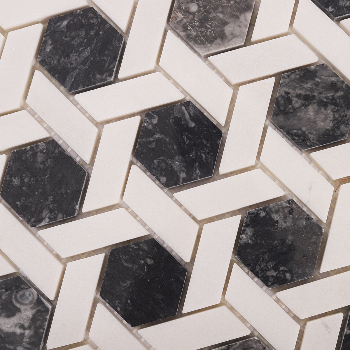 Close-up of gray and white hexagonal lattice marble mosaic tiles.