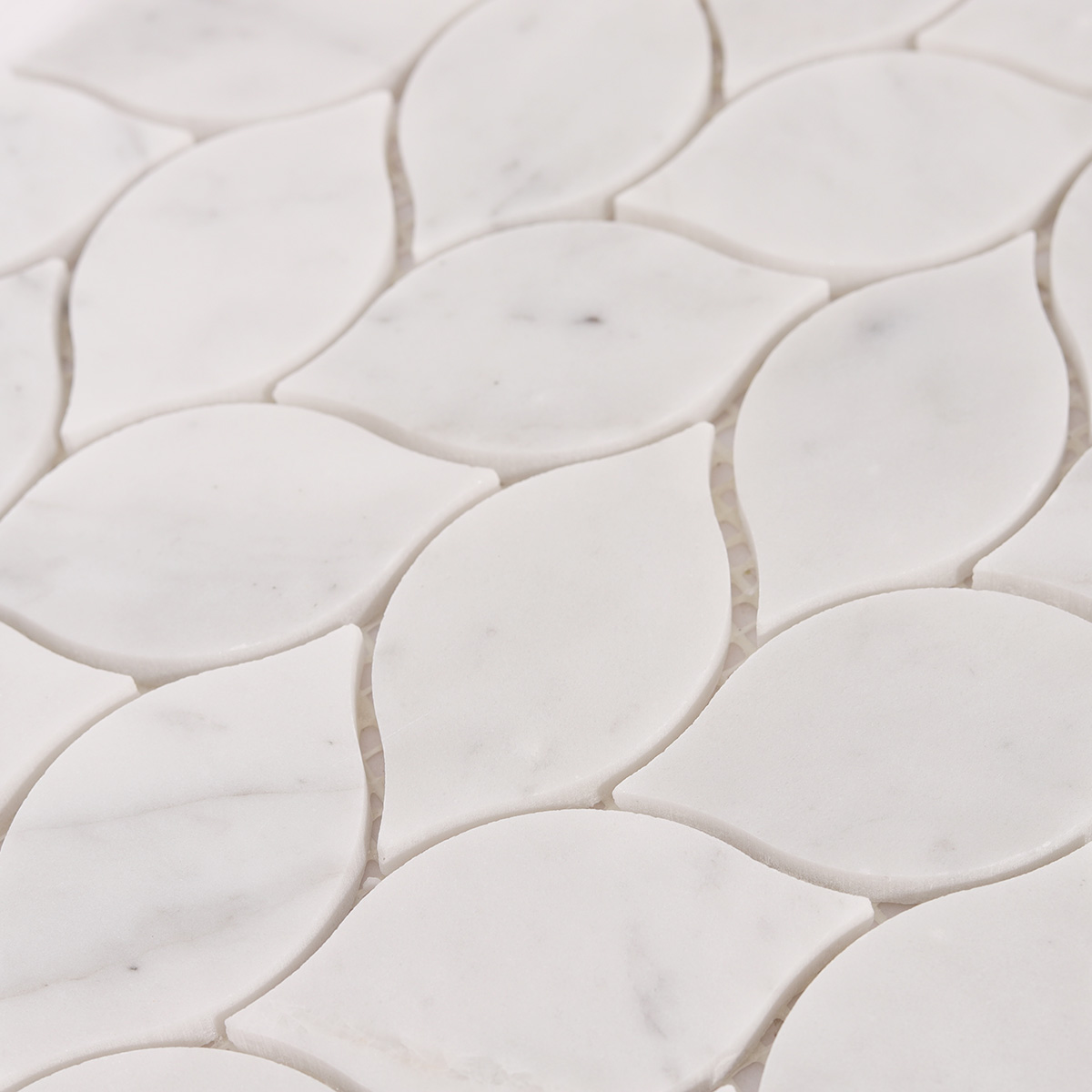 Close-up view of Carrara white leaf marble mosaic tiles